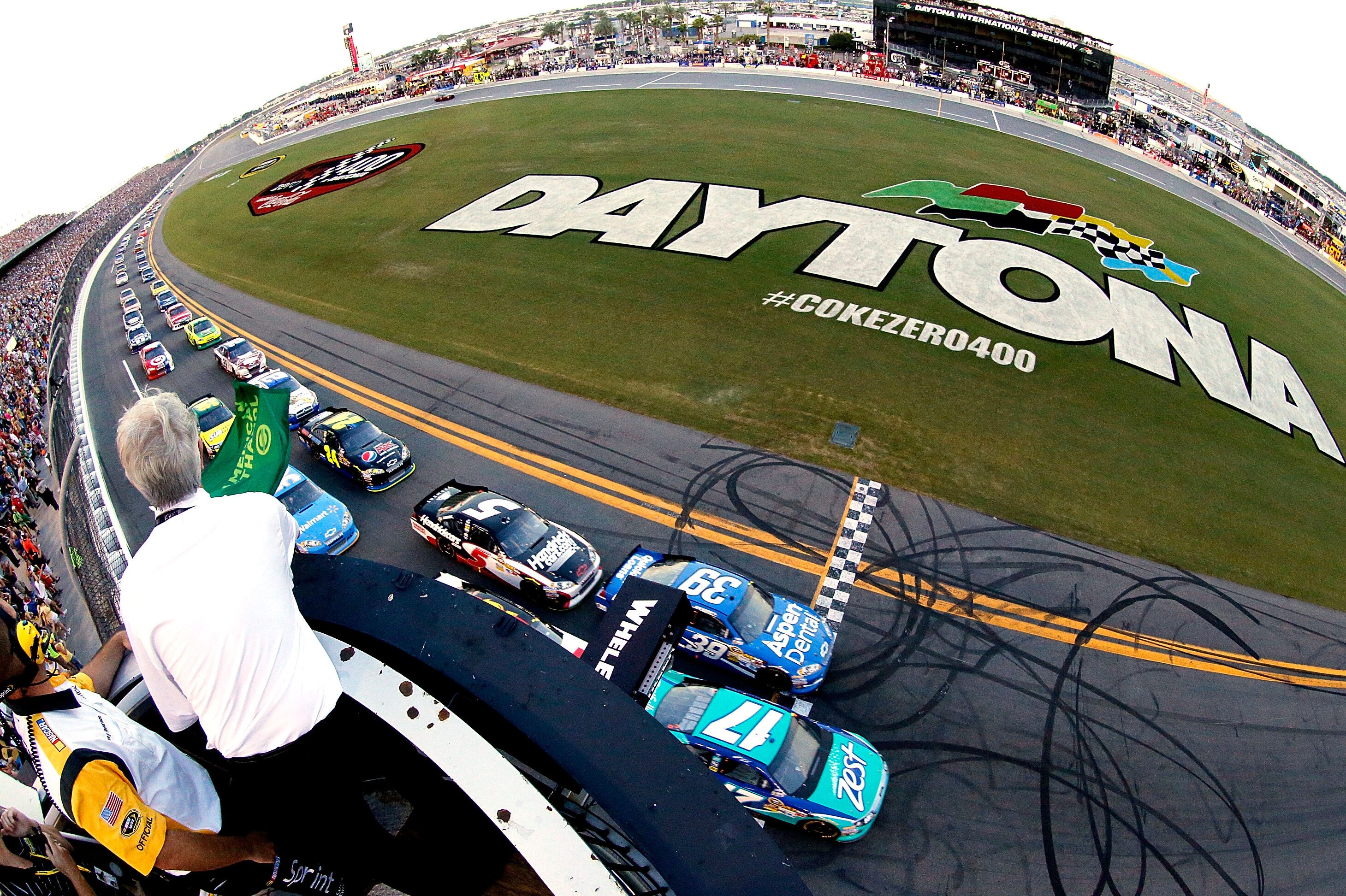 DAYTONA BEACH, FL - JULY 07: Matt Kenseth, driver of the #17 Zest Ford, and Ryan Newman, driver of the #39 Aspen Dental Chevrolet, lead the field to the green flag to start the NASCAR Sprint Cup Series Coke Zero 400 Powered by Coca-Cola at Daytona International Speedway on July 7, 2012 in Daytona Beach, Florida. (Photo by Tom Pennington/Getty Images)