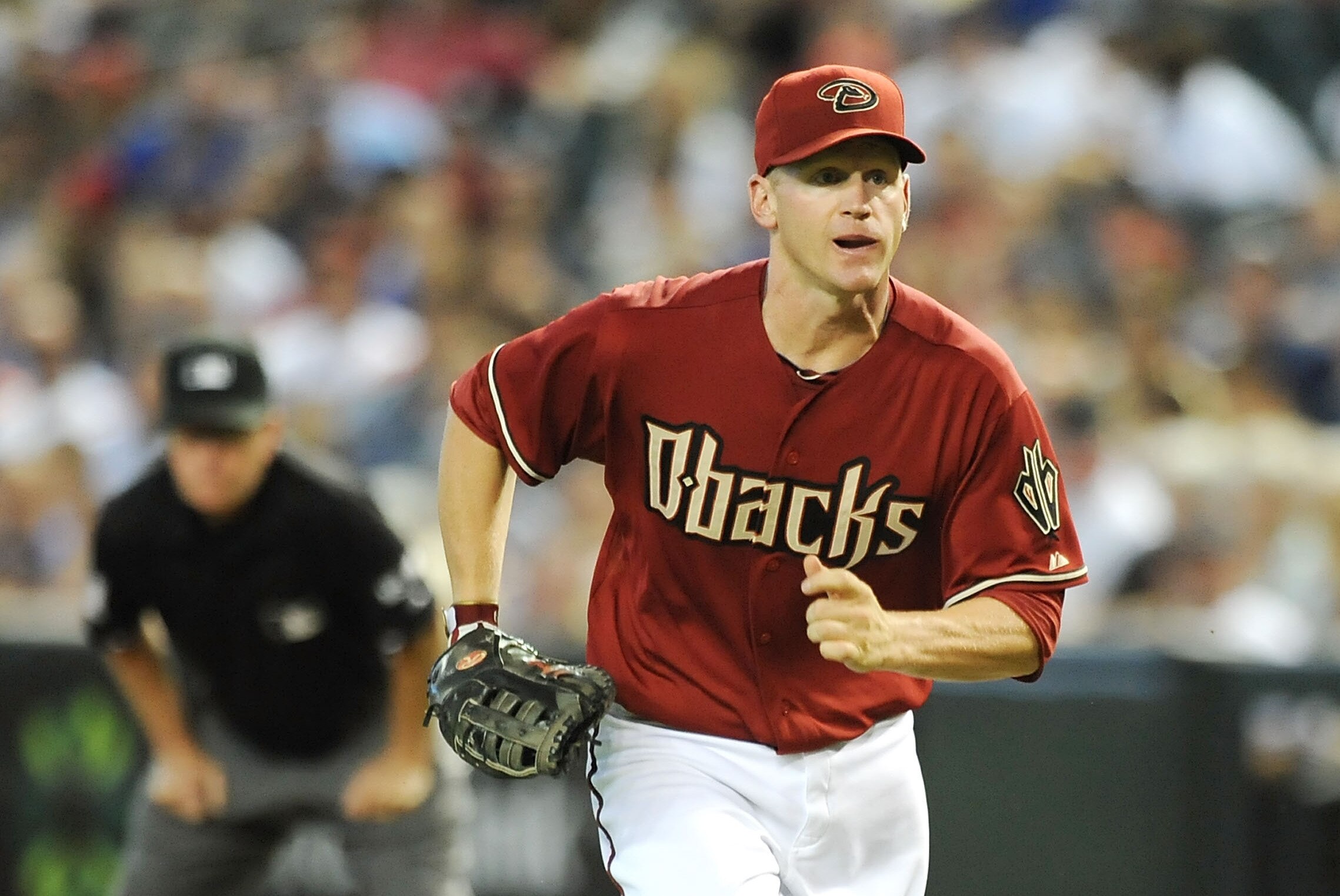 PHOENIX, AZ - JUNE 24: Lyle Overbay #37 of the Arizona Diamondbacks charges in to field a bunt against the Chicago Cubs at Chase Field on June 24, 2012 in Phoenix, Arizona. Arizona won 5-1. (Photo by Norm Hall/Getty Images)