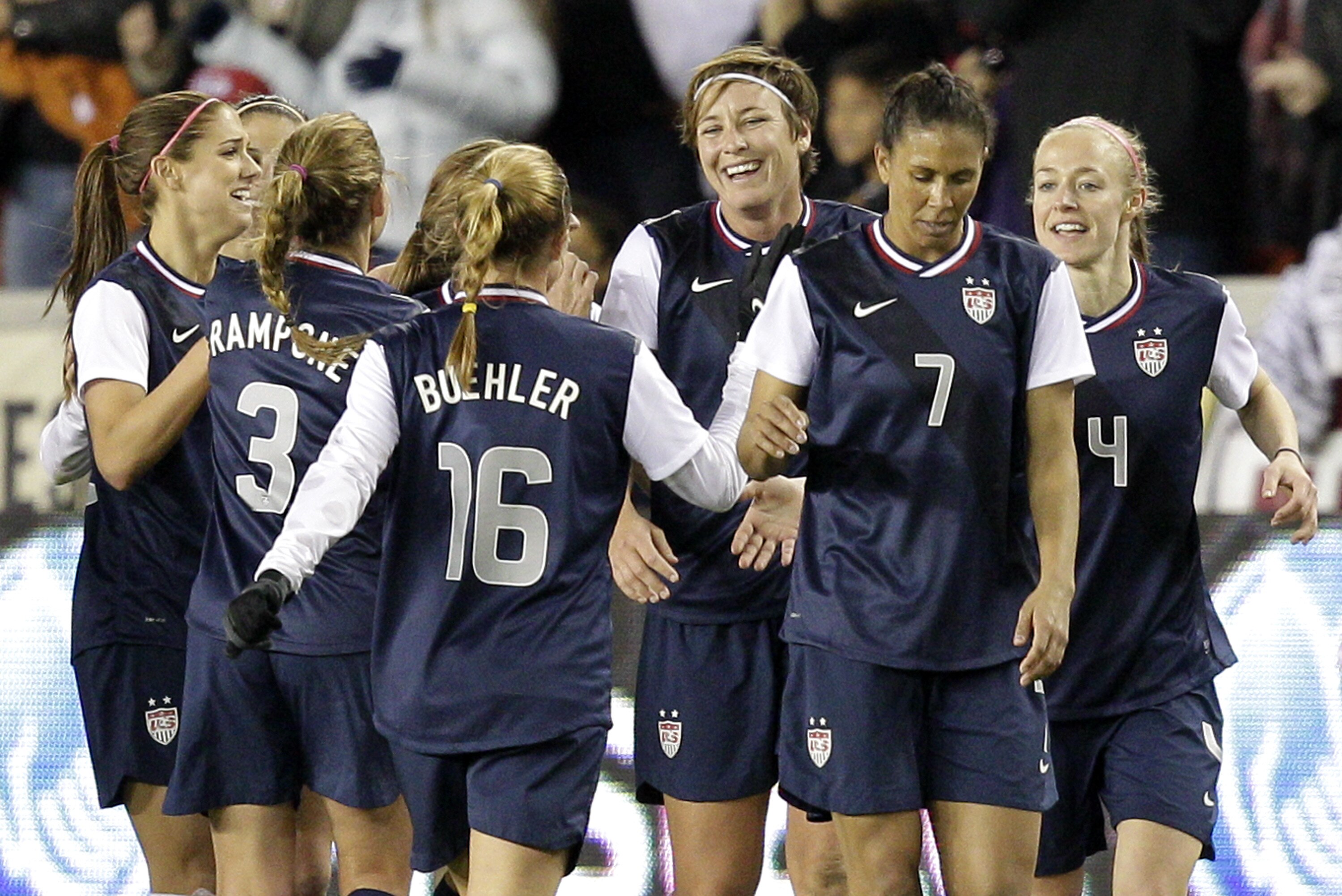 HOUSTON, TX - DECEMBER 12: Abby Wambach #14 of the United States celebrates her second goal of the game with her teammates in the second half at BBVA Compass Stadium on December 12, 2012 in Houston, Texas. Wambach's goal was her 150th international goal. USA won 4-0. (Photo by Bob Levey/Getty Images)