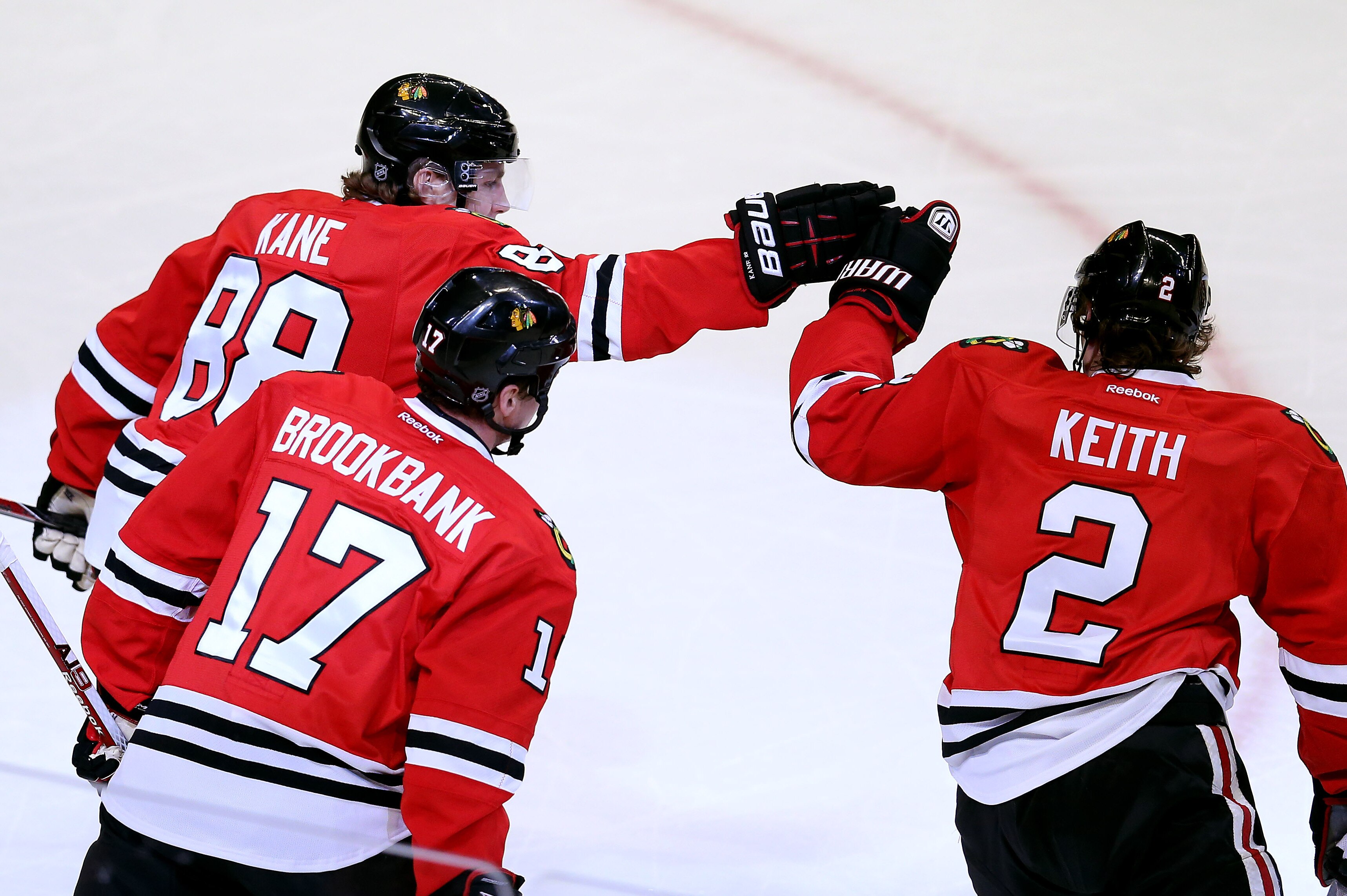 CHICAGO, IL - APRIL 26: Patrick Kane #88 of the Chicago Blackhawks celebrates his first period goal, his 23rd of the season, with teammates Duncan Keith #2 and Sheldon Brookbank #17 against the Calgary Flames at the United Center on April 26, 2013 in Chicago, Illinois. The Blackhawks defeated the Flames 3-1. (Photo by Jonathan Daniel/Getty Images)