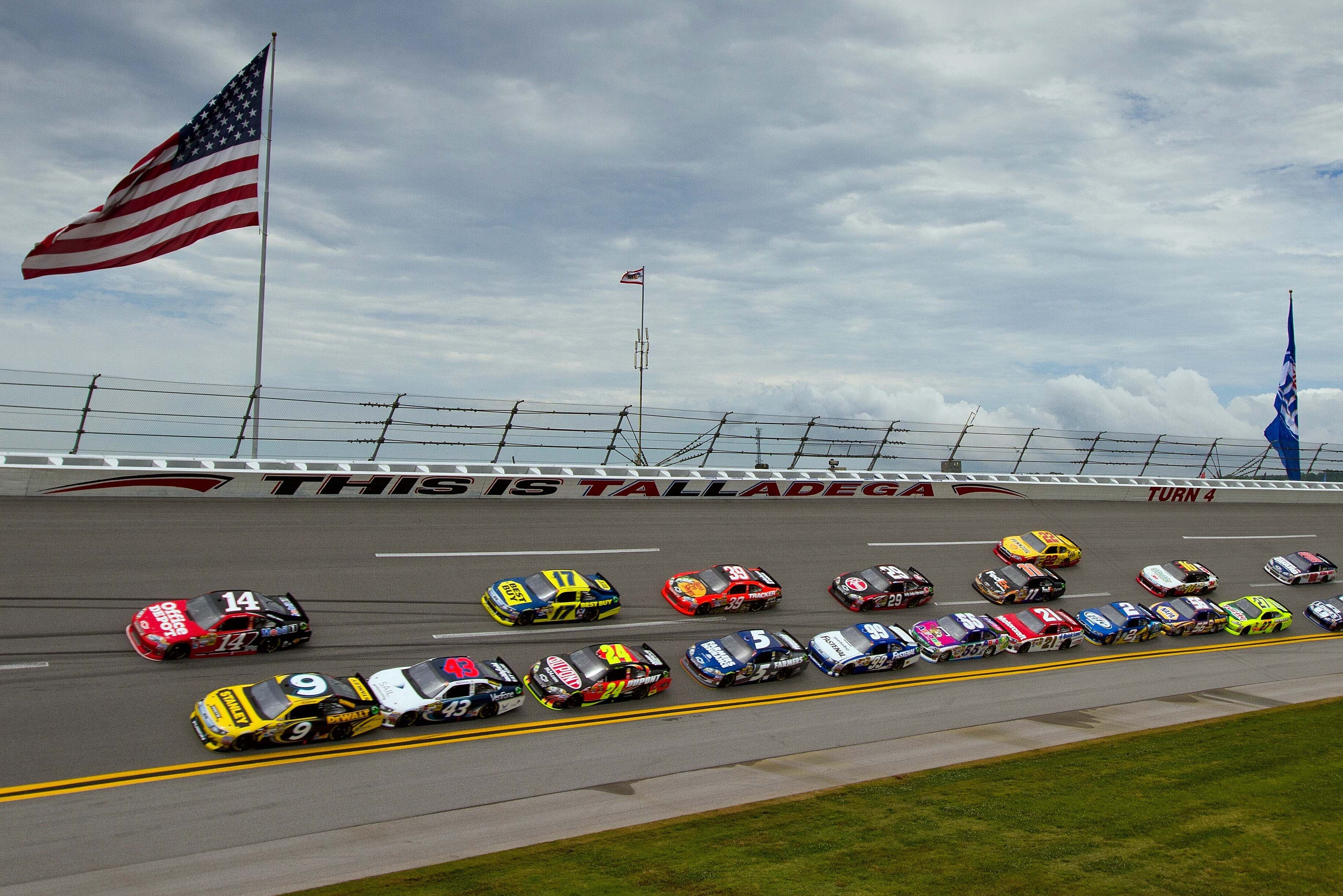 May 6, 2012; Talladega, AL, USA; A general view as NASCAR Sprint Cup Series cars race by an American Flag at the beginning of the Aarons 499 at Talladega Superspeedway. Mandatory Credit: Daniel Shirey-USA TODAY Sports