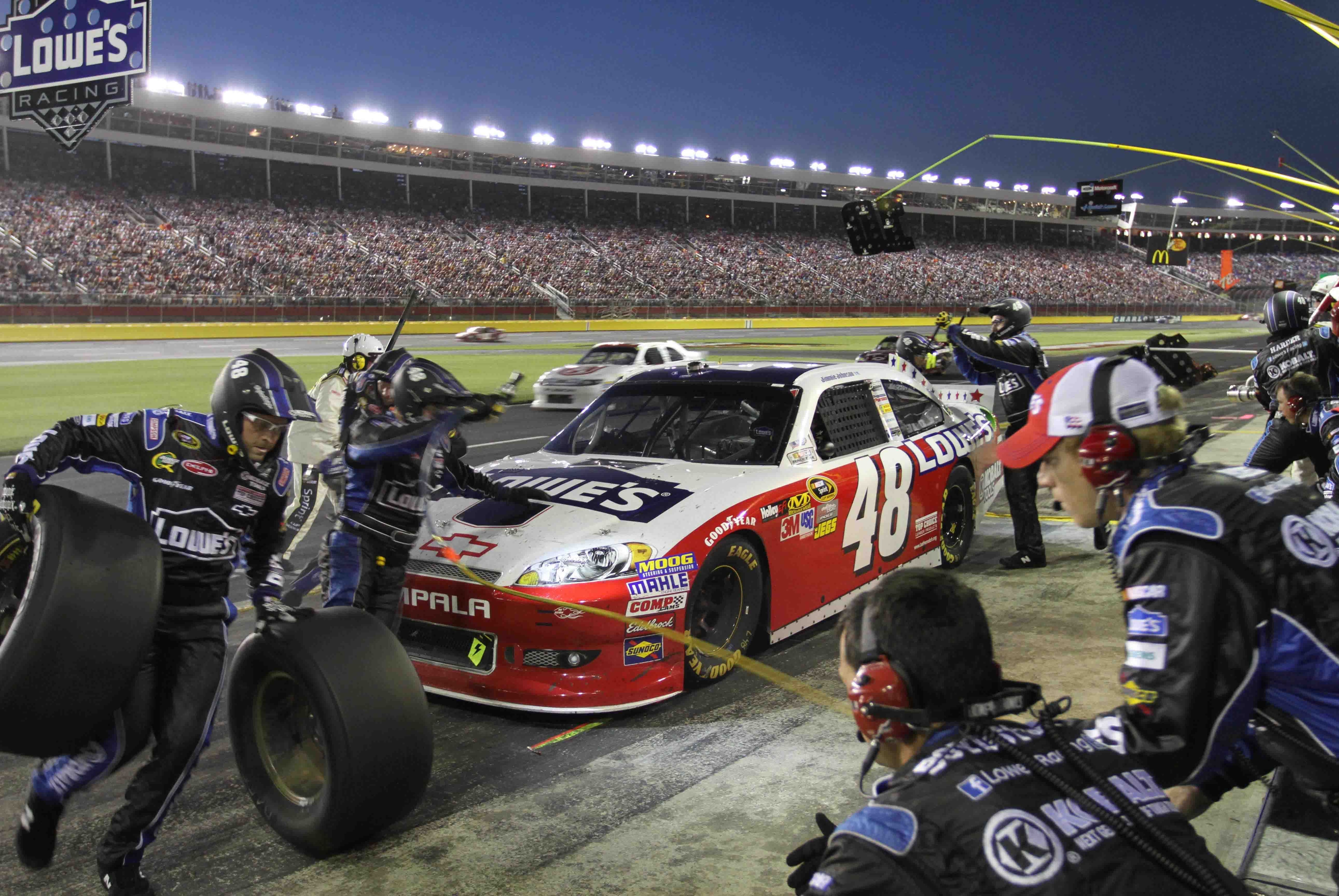 May 27, 2012; Charlotte, NC USA; NASCAR Sprint Cup Series driver Jimmie Johnson (48) makes a pit stop during the Coca-Cola 600 at Charlotte Motor Speedway. Mandatory Credit: Jeremy Brevard-USA TODAY Sports