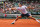 PARIS, FRANCE - MAY 31:  Roger Federer of Switzerland slides to play a backhand during his Men's Singles match against Julien Benneteau of France on day six of the French Open at Roland Garros on May 31, 2013 in Paris, France.  (Photo by Matthew Stockman/Getty Images)