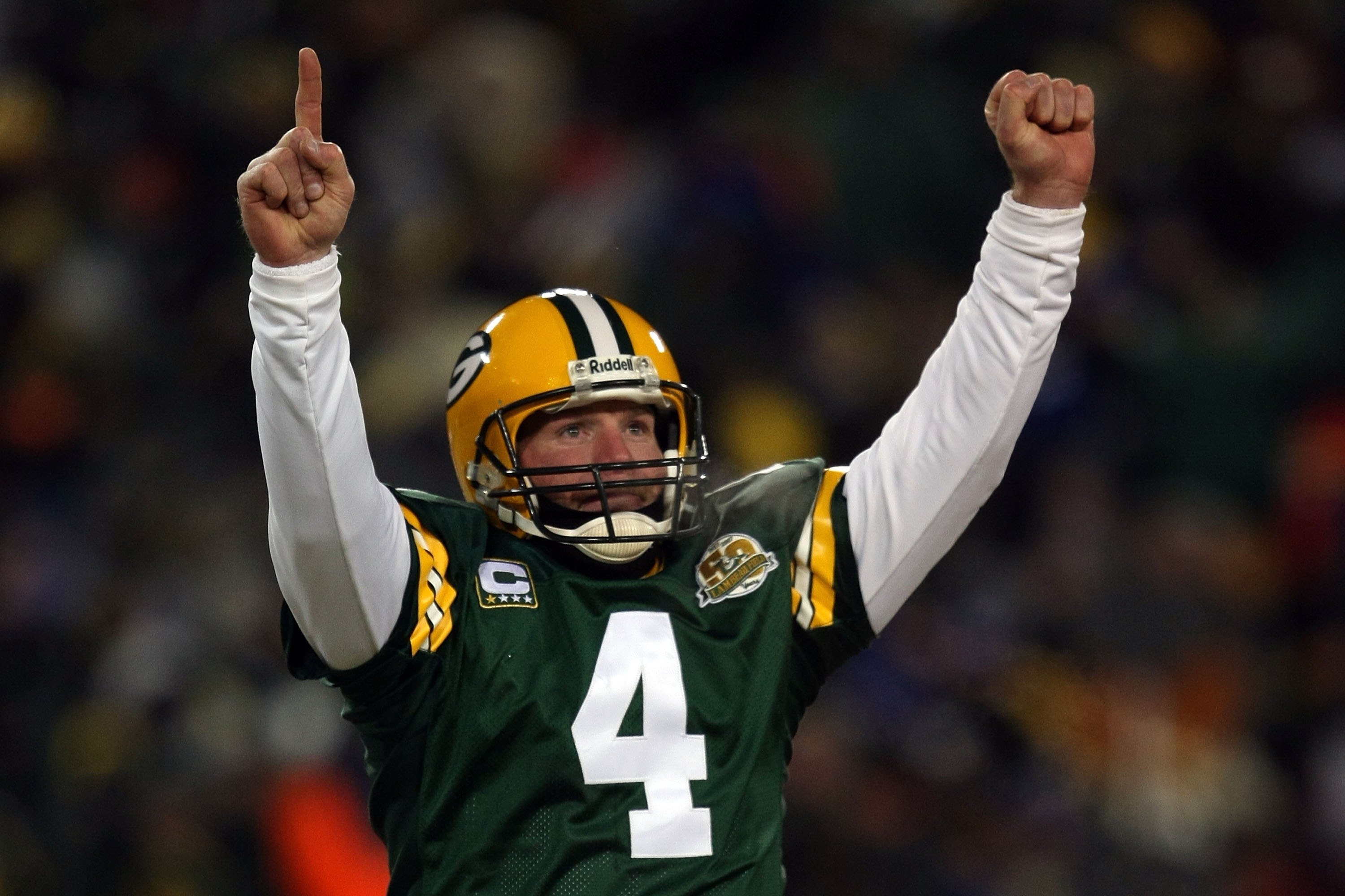 GREEN BAY, WI - JANUARY 20: Quarterback Brett Favre #4 of the Green Bay Packers reacts after a Packers touchdown during the NFC championship game against the New York Giants on January 20, 2008 at Lambeau Field in Green Bay, Wisconsin. The Giants defeated the Packers 23-20 in overtime to advance to the Superbowl XLII. (Photo by Jonathan Daniel/Getty Images)