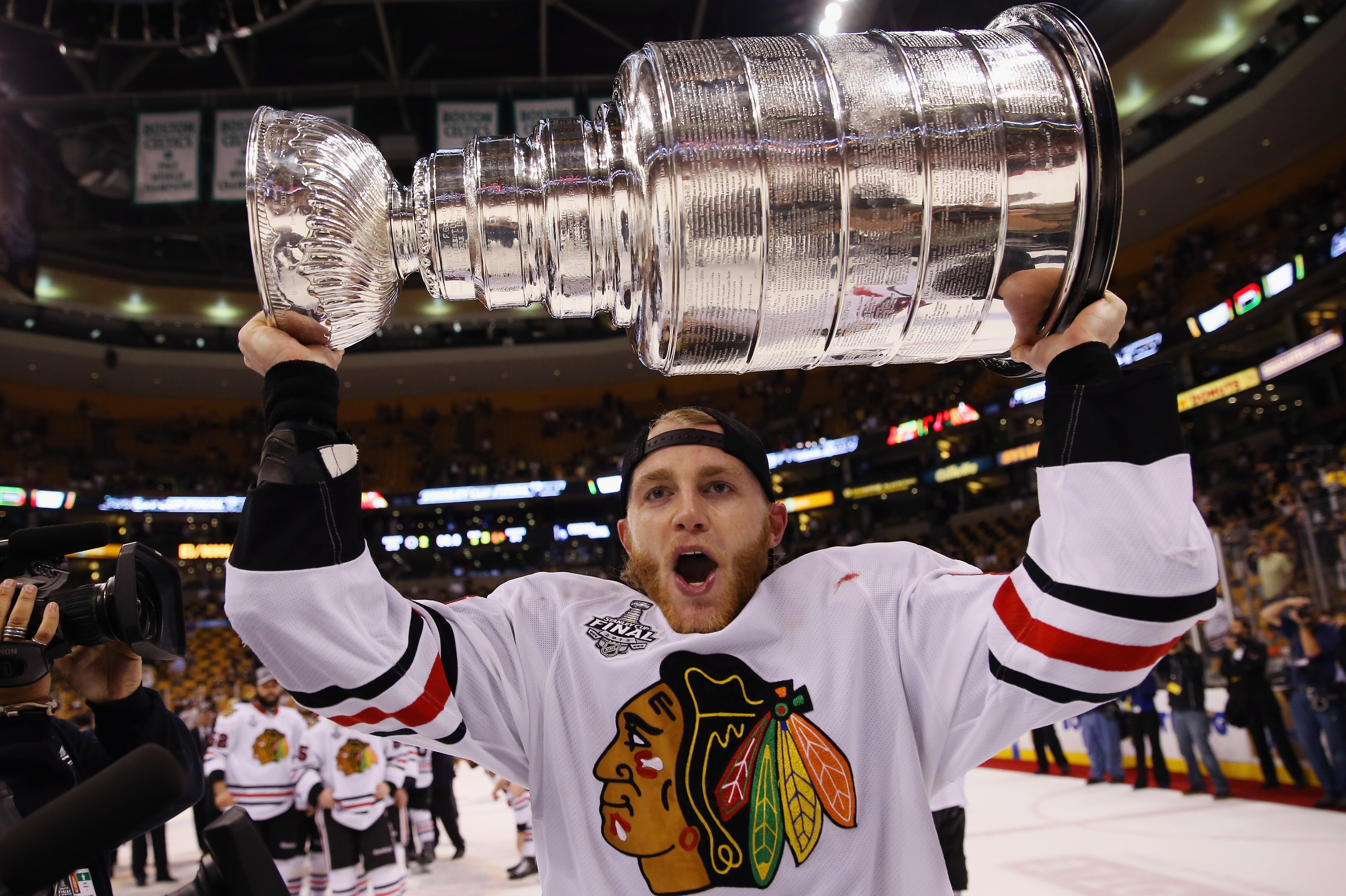 BOSTON, MA - JUNE 24: Patrick Kane #88 of the Chicago Blackhawks carries the Stanley Cup following a 3-2 victory over the Boston Bruins in Game Six of the 2013 NHL Stanley Cup Final the at TD Garden on June 24, 2013 in Boston, Massachusetts. (Photo by Bruce Bennett/Getty Images)