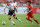 BANGKOK, THAILAND - JULY 28:  Seven Gerrard of Liverpool FC moves the ball away from Phutthinun Wansri (R) of Thailand national team during the international friendly match between Thailand and Liverpool at Rajamangala Stadium on July 28, 2013 in Bangkok, Thailand.  (Photo by Thananuwat Srirasant/Getty Images)