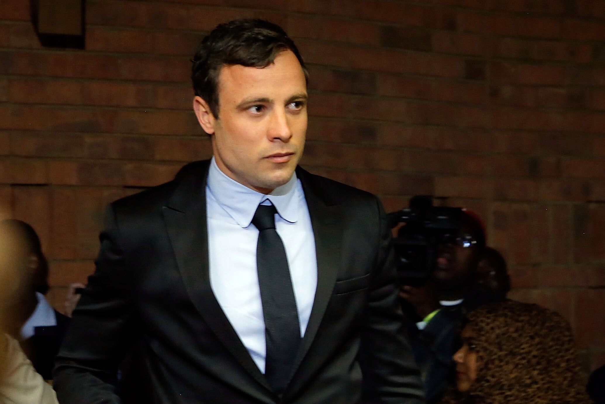 PRETORIA, SOUTH AFRICA - AUGUST 19: South African athlete Oscar Pistorius appears in Pretoria Magistrates Court for an indictment hearing on August 19, 2013 in Pretoria, South Africa. Pistorius, 26 is accused of murdering his girlfriend Reeva Steenkamp which Pistorius denies claiming he mistook Steenkamp for an intruder. The indictment was served and the trial date of March 3, 2014 was set in Pretoria Magistrates Court. (Photo by Jemal Countess/Getty Images)