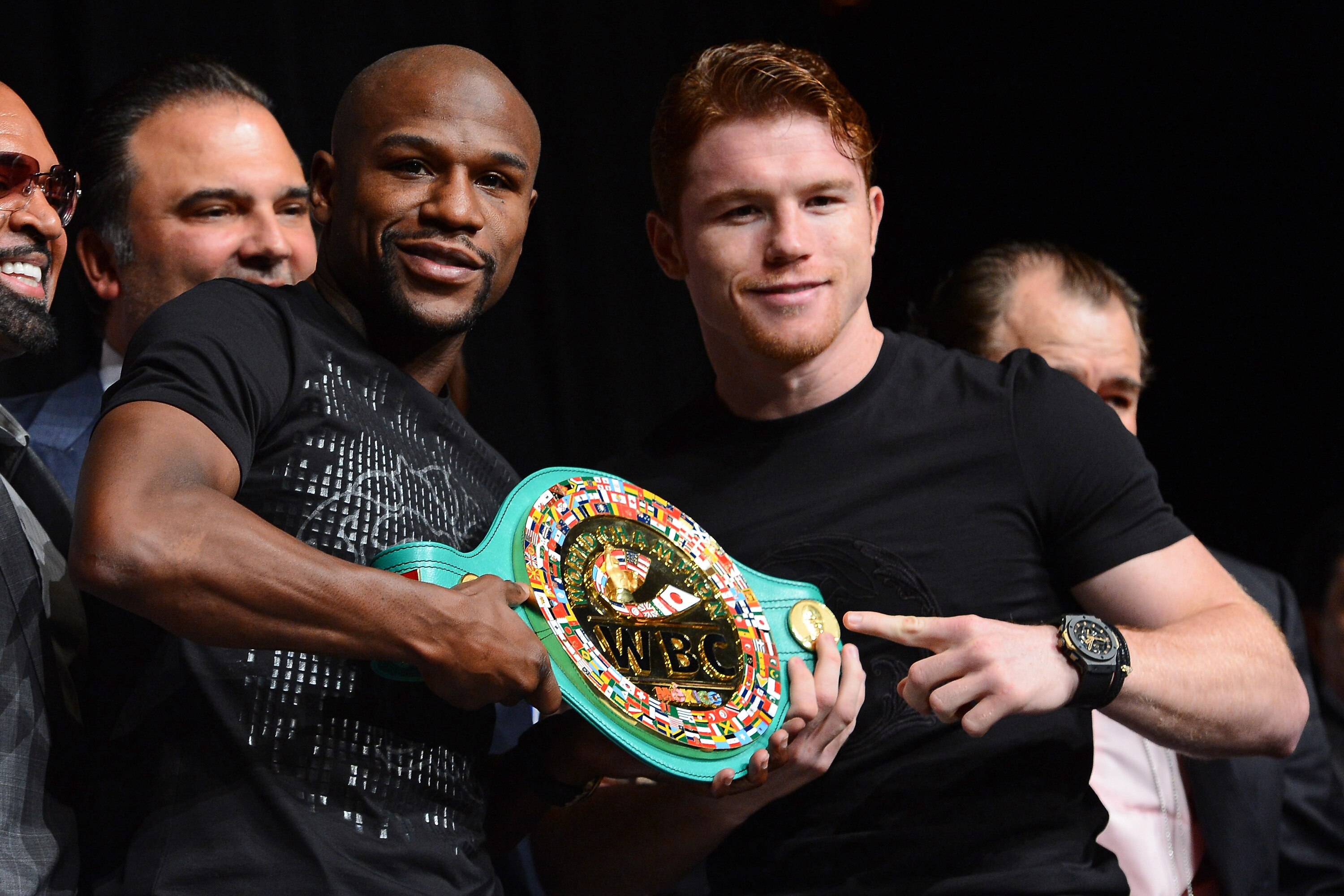 LAS VEGAS, NV - SEPTEMBER 11:  Boxers Floyd Mayweather Jr. (L) and Canelo Alvarez hold a WBC super welterweight championship belt during the final news conference for their bout at the MGM Grand Hotel/Casino on September 11, 2013 in Las Vegas, Nevada. The fighters will meet in a WBC/WBA 154-pound title fight on September 14 in Las Vegas.  (Photo by Ethan Miller/Getty Images)