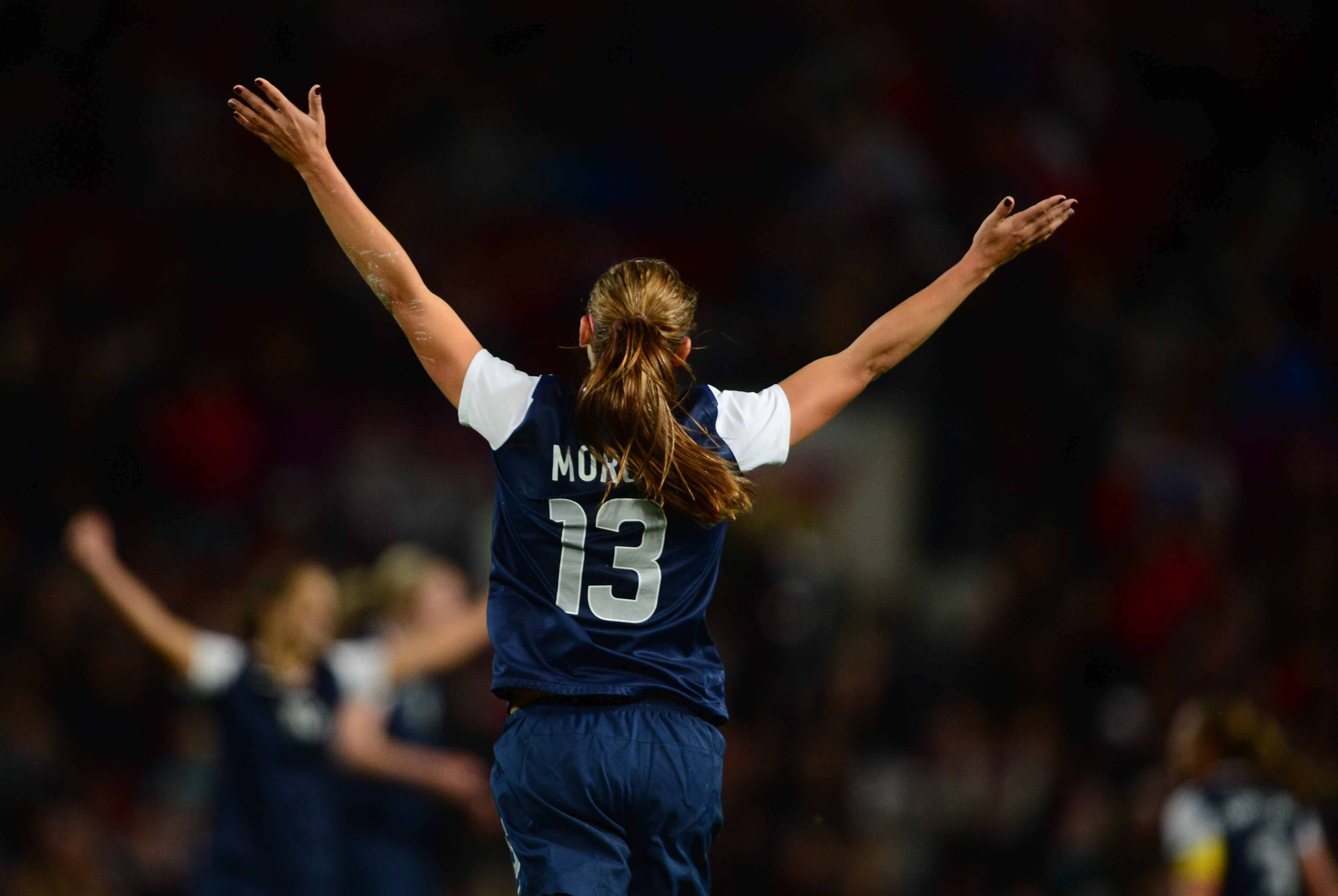 Aug 6, 2012; Manchester , United Kingdom; USA forward (13) Alex Morgan celebrates as the game ends after scoring the winning goal in extra time against Canada in the semi finals during the London 2012 Olympic Games at Old Trafford. Mandatory Credit: Mark J. Rebilas-USA TODAY Sports
