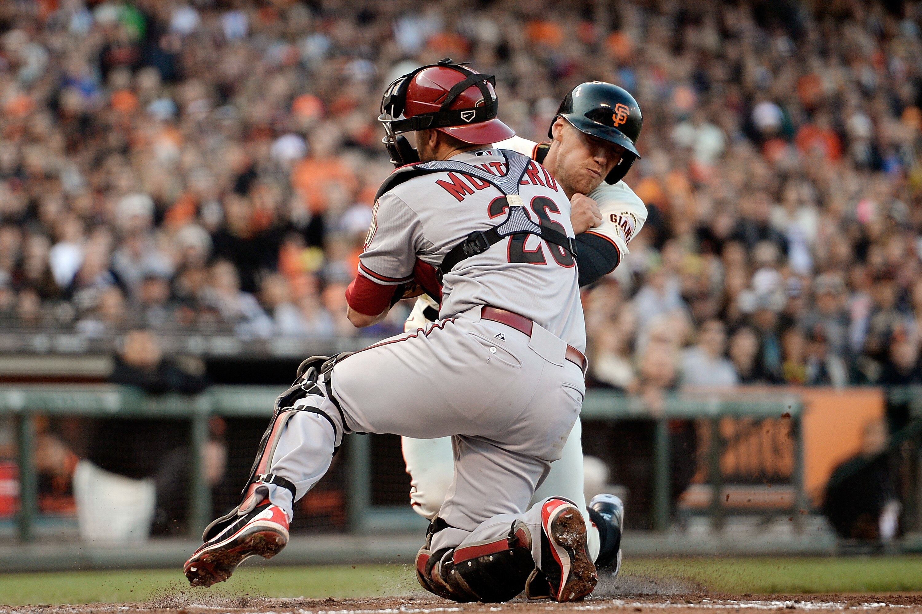 SAN FRANCISCO, CA - JULY 20: Hunter Pence #8 of the San Francisco Giants attempting to score on a ground ball to third base is tagged out, colliding with catcher Miguel Montero #26 of the Arizona Diamondback in the fourth inning at AT&T Park on July 20, 2013 in San Francisco, California. (Photo by Thearon W. Henderson/Getty Images)