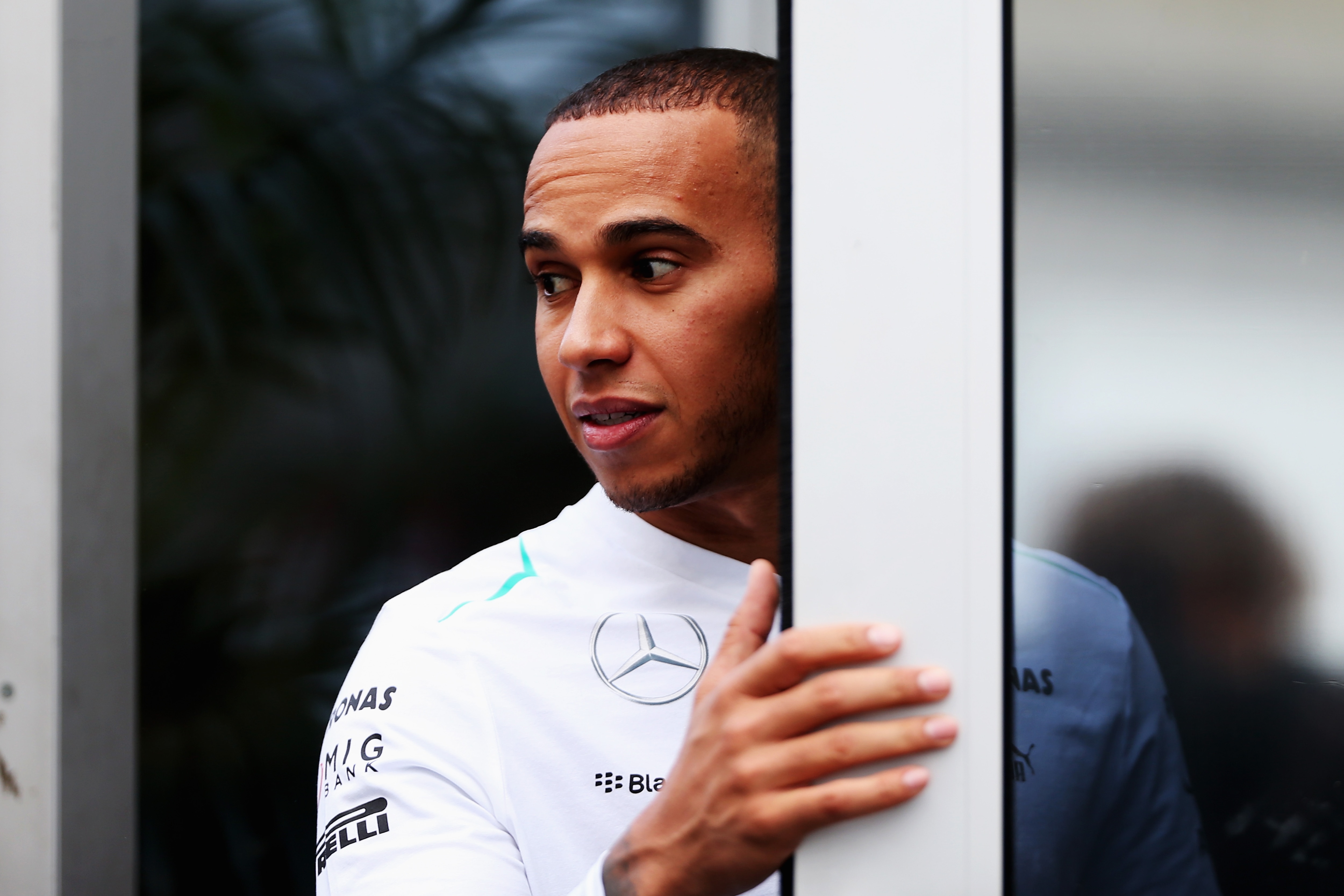 AUSTIN, TX - NOVEMBER 14: Lewis Hamilton of Great Britain and Mercedes GP talks to colleagues in the paddock during previews to the United States Formula One Grand Prix at Circuit of The Americas on November 14, 2013 in Austin, United States. (Photo by Mark Thompson/Getty Images)