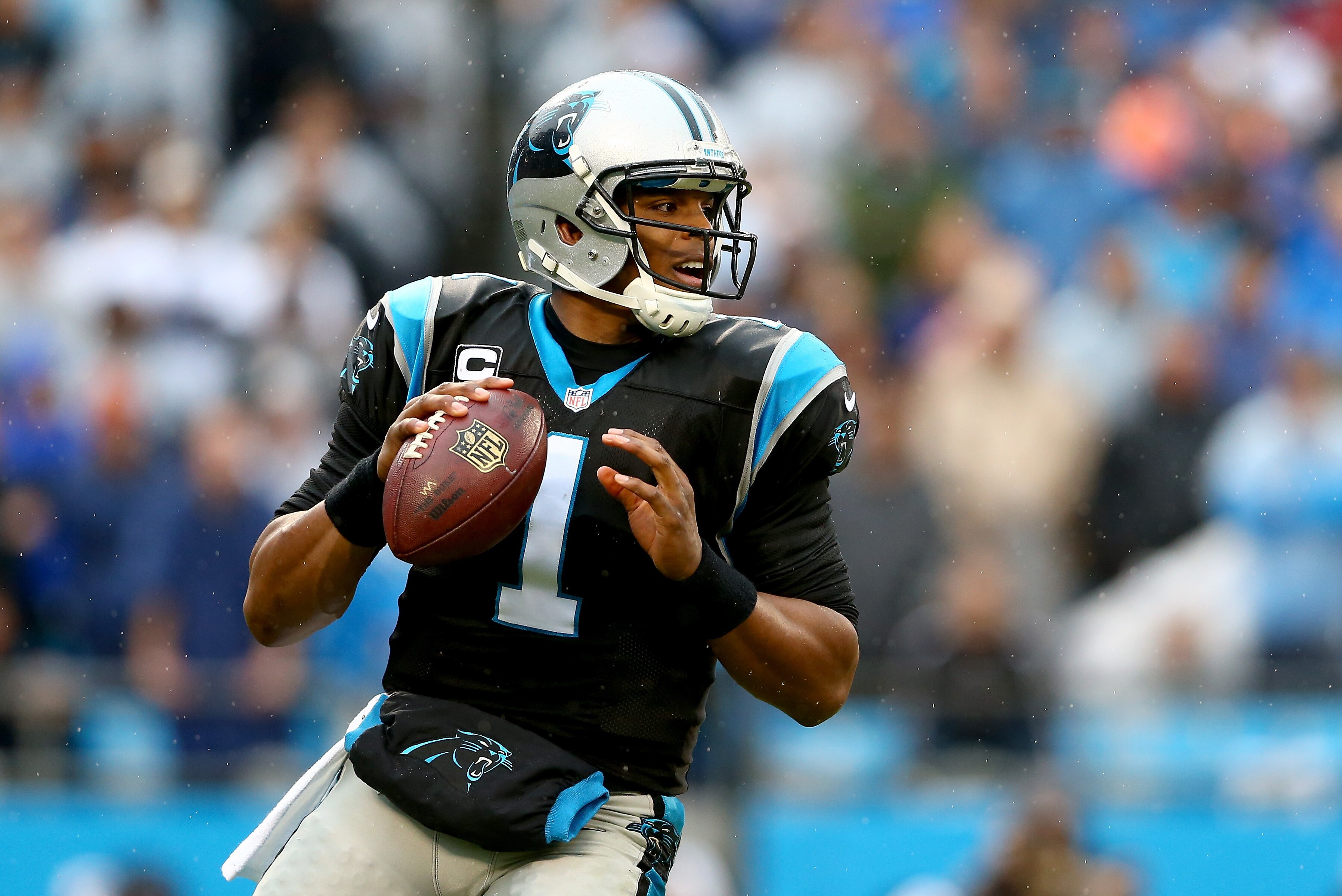 CHARLOTTE, NC - DECEMBER 22: Cam Newton #1 of the Carolina Panthers drops back to pass during their game against the New Orleans Saints at Bank of America Stadium on December 22, 2013 in Charlotte, North Carolina. (Photo by Streeter Lecka/Getty Images)