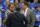 Referee John Higgins, middle, explains a call to Oklahoma State head coach Travis Ford, left, and Kansas head coach Bill Self, right, during the first half of an NCAA college basketball game at Allen Fieldhouse in Lawrence, Kan., Saturday, Jan. 18, 2014. (AP Photo/Orlin Wagner)