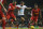 Tottenham's Andros Townsend, centre attempts to take the ball past Liverpool's Glen Johnson, right, during their English Premier League soccer match between Tottenham Hotspur and Liverpool at the White Hart Lane stadium in London Sunday, Dec  15  2013. Liverpool won the game 5-0.(AP Photo/Alastair Grant)