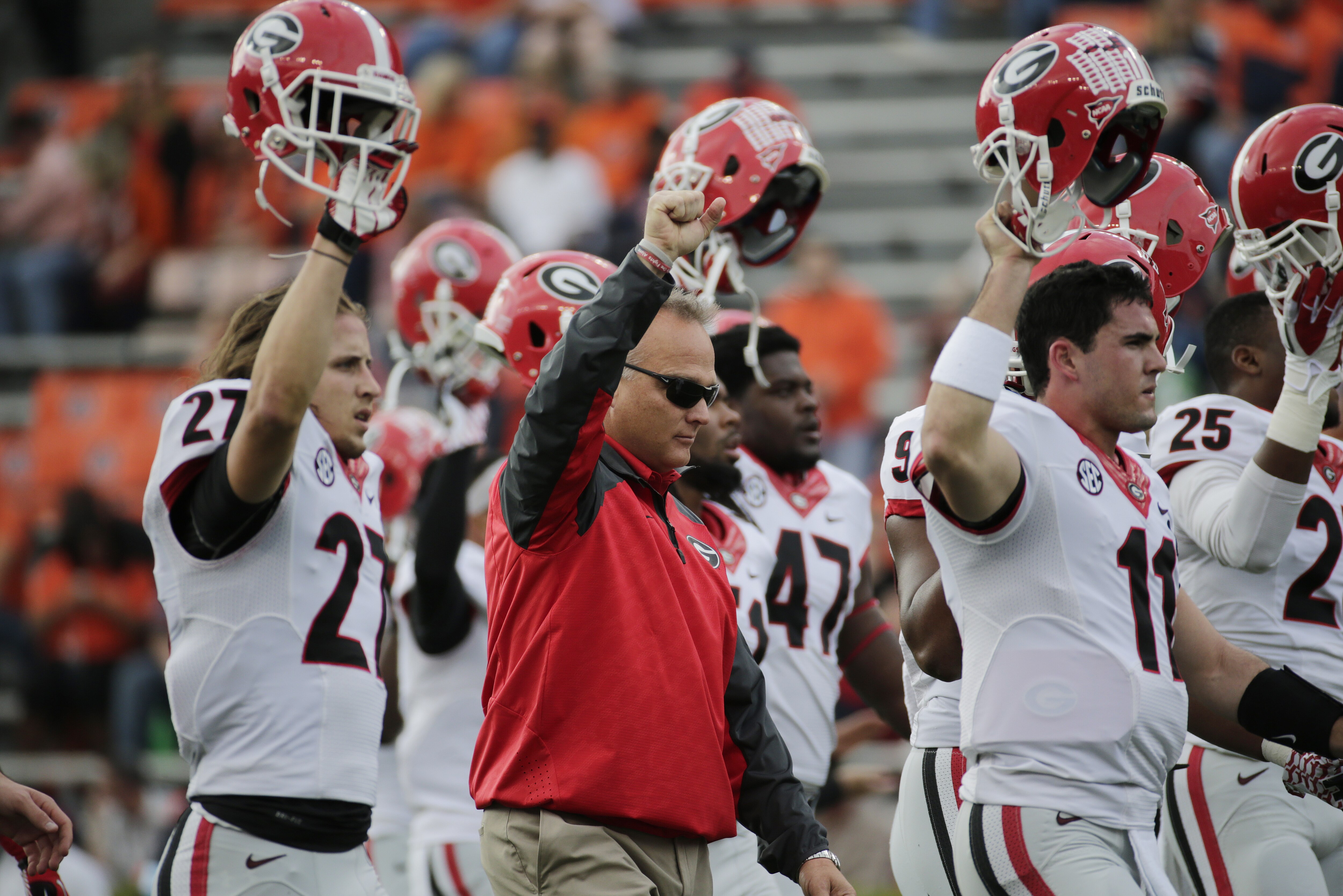 Georgia head coach Mark Richt, center, and his players hold their helmets high prior to the start of an NCAA college football game against Auburn in Auburn, Ala., Saturday, Nov. 16, 2013. (AP Photo/Dave Martin)