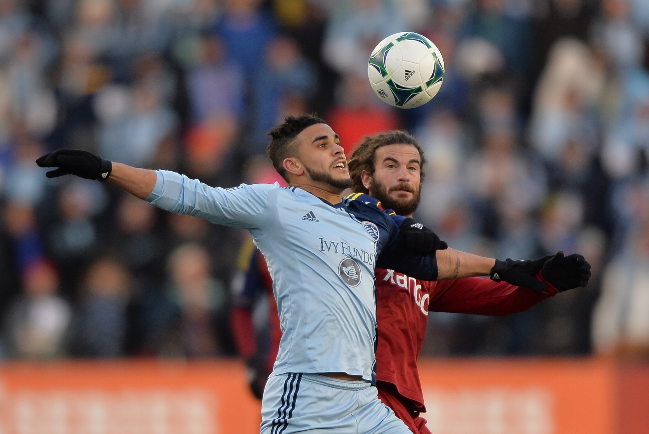 Dec 7, 2013; Kansas City, KS, USA; Sporting KC forward Dom Dwyer (left) and Real Salt Lake midfielder Kyle Beckerman (right) fight for the ball during the first half of the 2013 MLS Cup at Sporting Park. Mandatory Credit: Peter G. Aiken-USA TODAY Sports