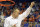 Florida coach Billy Donovan holds up a piece of the net after the Gators became the first team in Southeastern Conference history to go 18-0 in league pla, Saturday, March 8, 2014 in Gainesville, Fla. Florida defeated Kentucky 84-65 Saturday in an NCAA college basketball game. (AP Photo/Phil Sandlin)