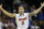 Florida guard Scottie Wilbekin (5) celebrates his basket against Dayton's Vee Sanford during the first half in a regional final game at the NCAA college basketball tournament, Saturday, March 29, 2014, in Memphis, Tenn. (AP Photo/John Bazemore)