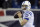 Indianapolis Colts quarterback Andrew Luck warms up in the rain before an AFC divisional NFL playoff football game against the New England Patriots in Foxborough, Mass., Saturday, Jan. 11, 2022. (AP Photo/Stephan Savoia)