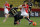 Monaco's James Rodriguez, right, challenges for the ball with Reims' player Aissa Mandi their French League One soccer match, in Monaco stadium, Friday, Feb. 21 , 2014. (AP Photo/Lionel Cironneau)