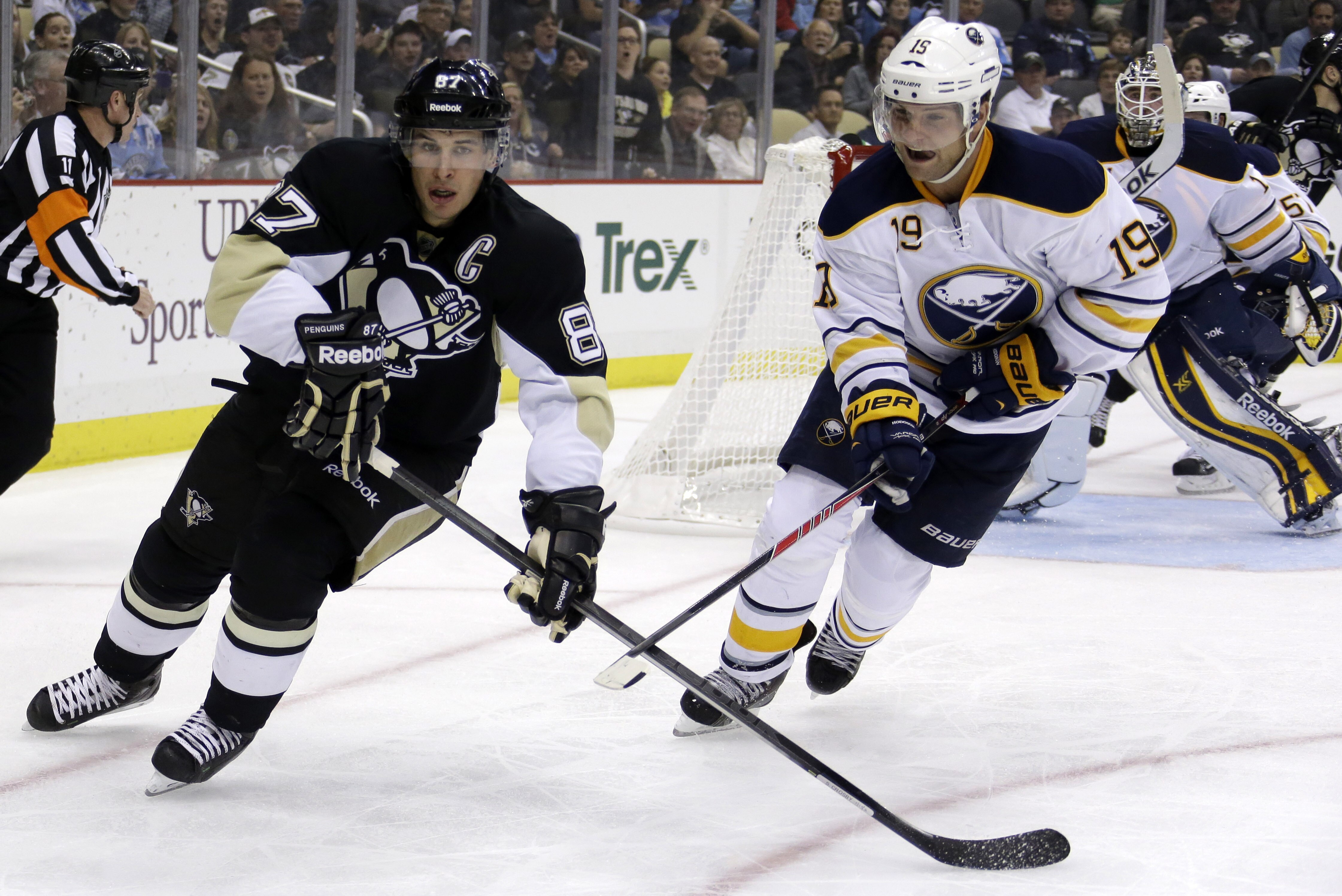 Pittsburgh Penguins' Sidney Crosby (87) and Buffalo Sabres center Cody Hodgson (19) skate during the second period of a NHL hockey game in Pittsburgh Saturday, Oct. 5, 2013. The Penguins won 4-1. (AP Photo/Gene J. Puskar)