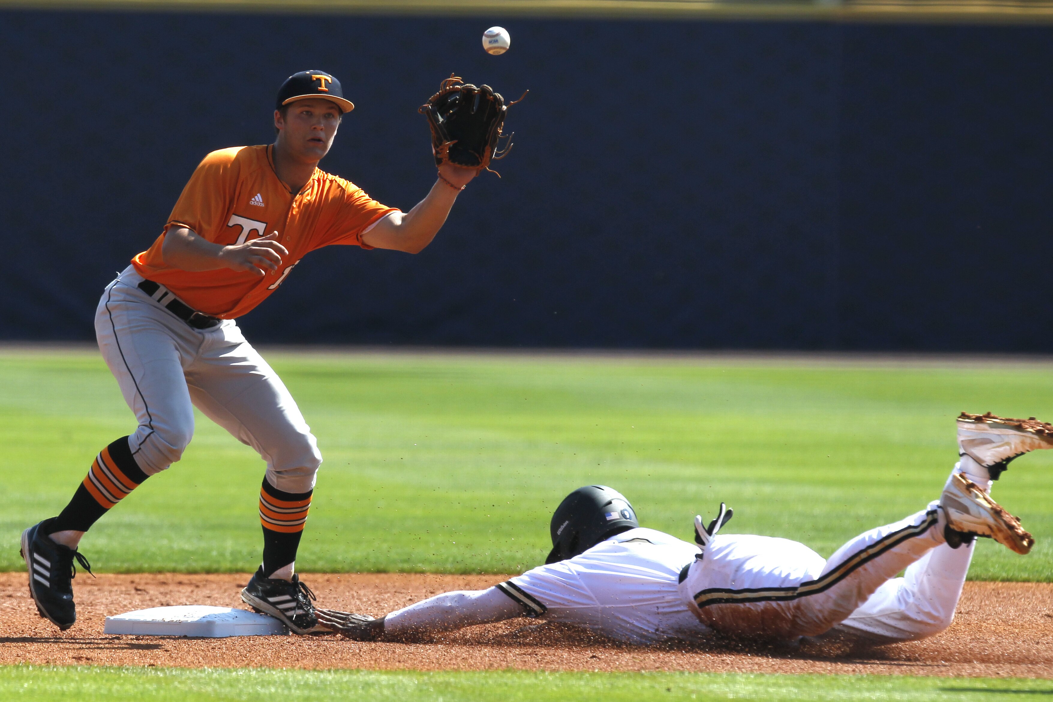 Vanderbilt's Xavier Turner beats the throw to Tennessee's Nick Senzel (13) as he slides into second base during the Southeastern Conference NCAA college baseball tournament on Tuesday, May 20, 2014, in Hoover, Ala. (AP Photo/Butch Dill)