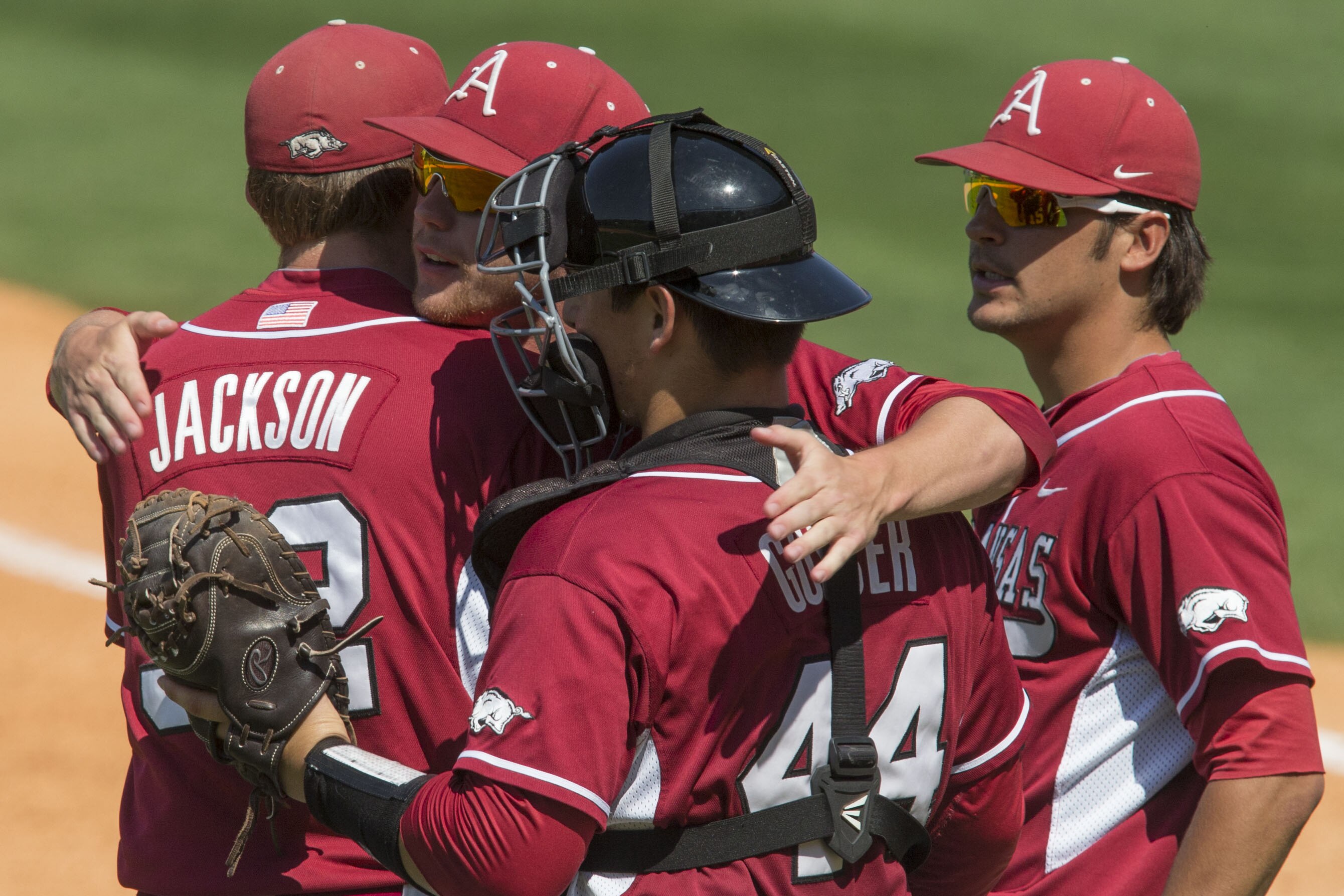 Arkansas players Zach Jackson, Alex Gosser, Trey Killian and Arkansas' Garrett Rucker celebrate after the team's 4-0 win over Texas A&M during the Southeastern Conference NCAA college baseball tournament Tuesday, May 20, 2014, in Hoover, Ala. (AP Photo/Hal Yeager)