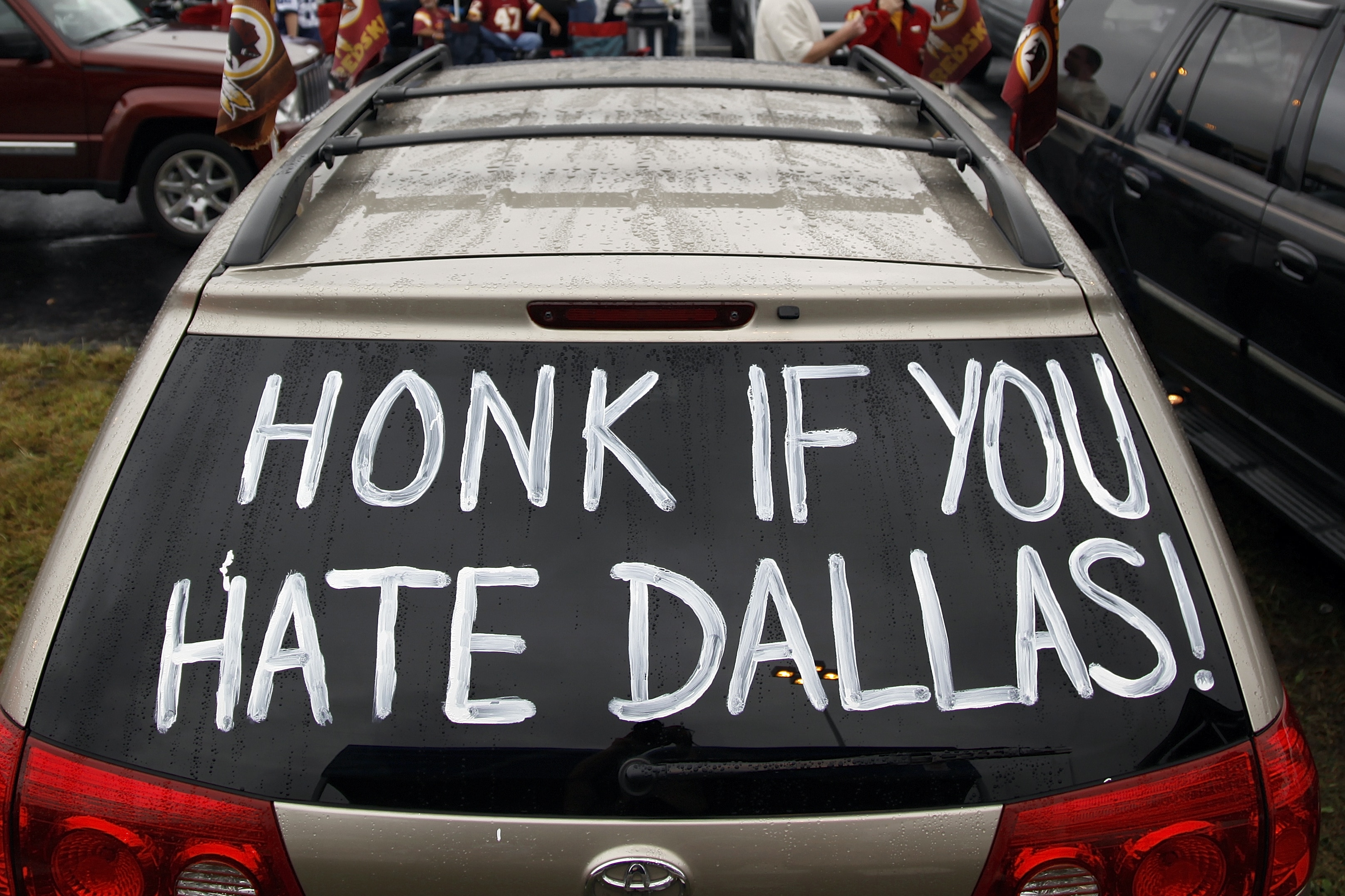 A Washington Redskins fan parked car outside of the FedEx Field displays a hand painted sign before an NFL football game against the Dallas Cowboys in Landover, Md., on Sunday, Sept.. 12, 2010. (AP Photo/Evan Vucci)