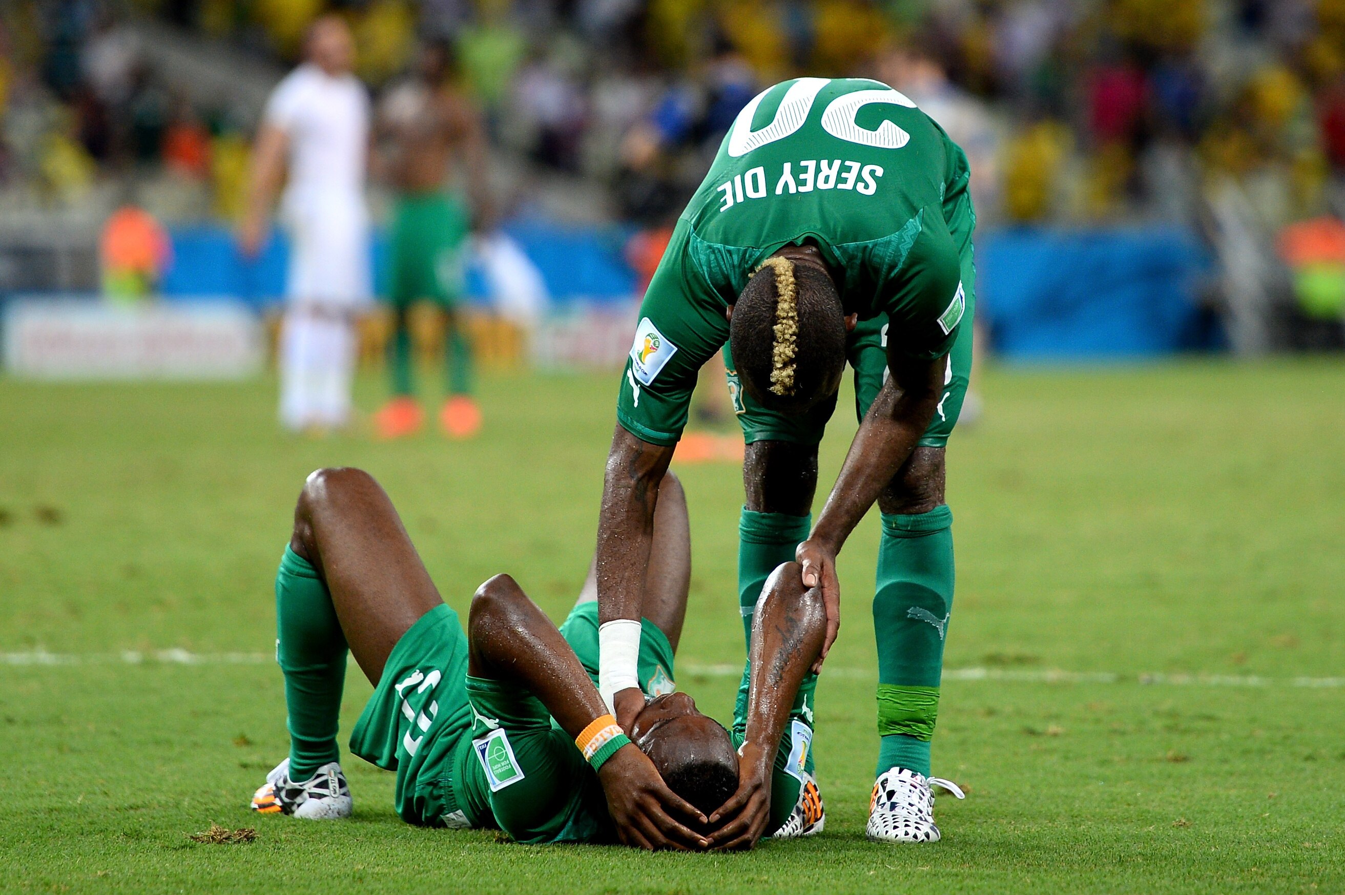 FORTALEZA, BRAZIL - JUNE 24: A dejected Giovanni Sio of the Ivory Coast is consoled by teammate Die Serey after being defeated by Greece 2-1 during the 2014 FIFA World Cup Brazil Group C match between Greece and the Ivory Coast at Castelao on June 24, 2014 in Fortaleza, Brazil. (Photo by Jamie McDonald/Getty Images)