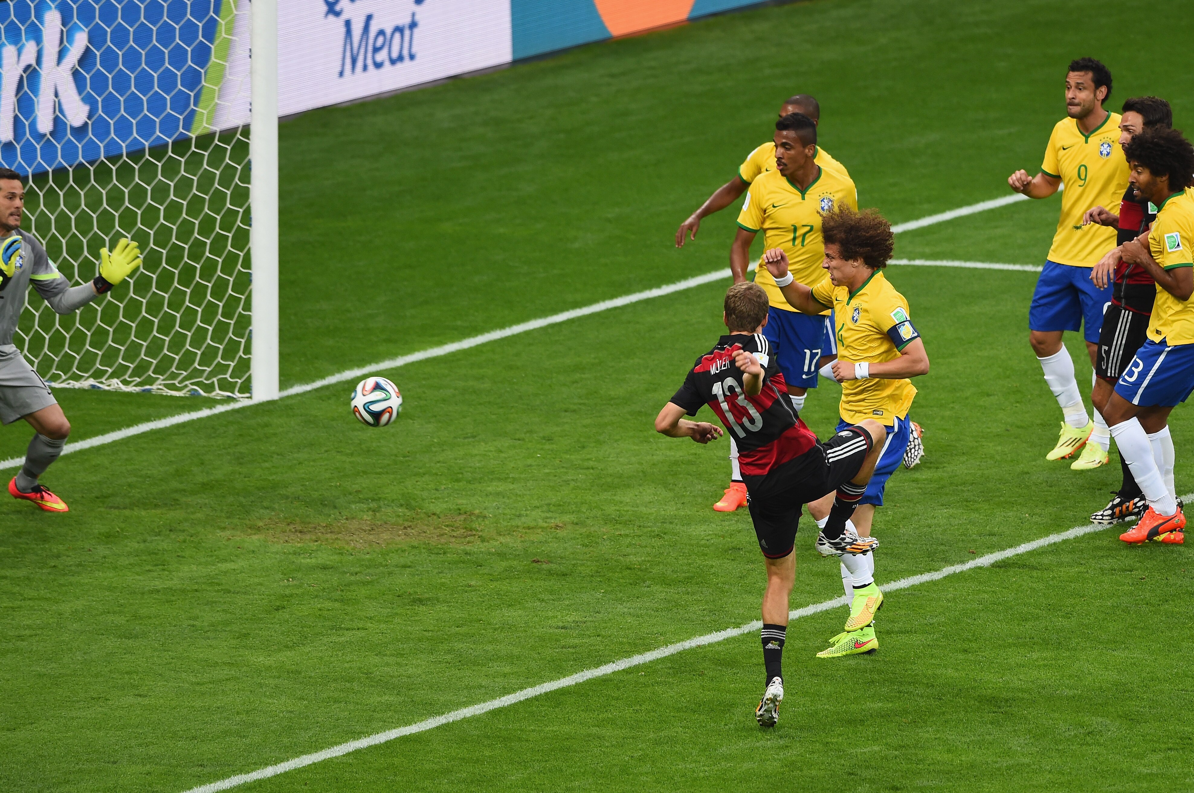 BELO HORIZONTE, BRAZIL - JULY 08: Thomas Mueller of Germany scores his team's first goal past David Luiz and goalkeeper Julio Cesar of Brazil during the 2014 FIFA World Cup Brazil Semi Final match between Brazil and Germany at Estadio Mineirao on July 8, 2014 in Belo Horizonte, Brazil. (Photo by Jamie McDonald/Getty Images)
