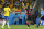 Germany's Sami Khedira celebrates after scoring his side's fifth goal as Brazil's David Luiz, left, passes by during the World Cup semifinal soccer match between Brazil and Germany at the Mineirao Stadium in Belo Horizonte, Brazil, Tuesday, July 8, 2014. (AP Photo/Frank Augstein)