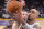 Memphis Grizzlies guard Nick Calathes, left, blocks the shot of Los Angeles Lakers center Robert Sacre during the second half of an NBA basketball game, Sunday, April 13, 2014, in Los Angeles. The Grizzlies won 102-90. (AP Photo/Mark J. Terrill)