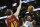 Boston Celtics' Jared Sullinger (7) shoots over Cleveland Cavaliers' Tyler Zeller (40) in the fourth quarter of an NBA basketball game in Boston, Saturday, Dec. 28, 2013. The Celtics won 103-100. (AP Photo/Michael Dwyer)