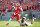 RALEIGH, NC - SEPTEMBER 27: Jacoby Brissett #12 of the North Carolina State Wolfpack breaks free from DeMarcus Walker #44 of the Florida State Seminoles to throw a touchdown pass during the first quarter of their game at Carter-Finley Stadium on September 27, 2014 in Raleigh, North Carolina. (Photo by Grant Halverson/Getty Images)
