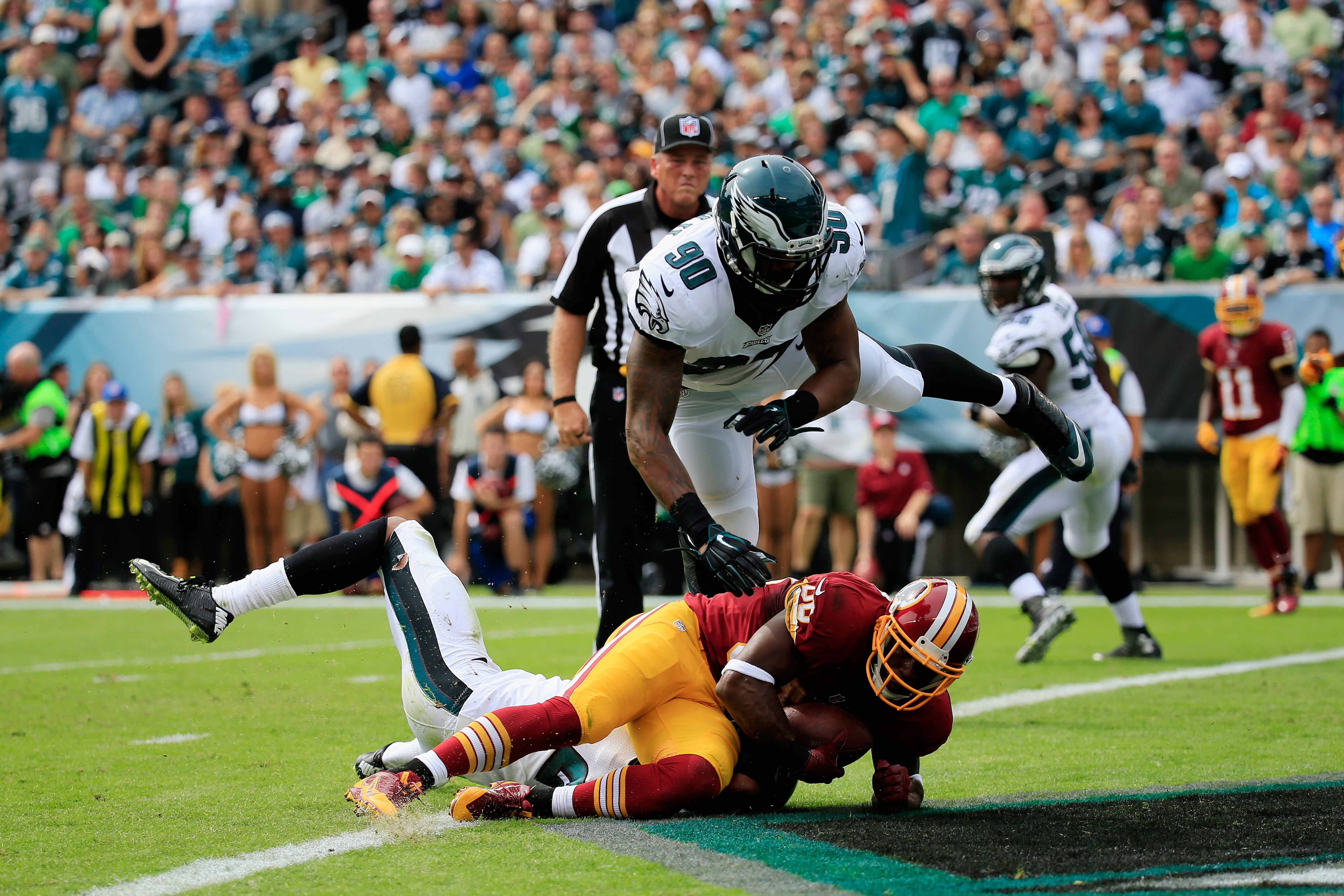 PHILADELPHIA, PA - SEPTEMBER 21: Pierre Garcon #88 of the Washington Redskins scores a touchdown against Marcus Smith #90 of the Philadelphia Eagles in the first quarter of the game at Lincoln Financial Field on September 21, 2014 in Philadelphia, Pennsylvania. (Photo by Rob Carr/Getty Images)