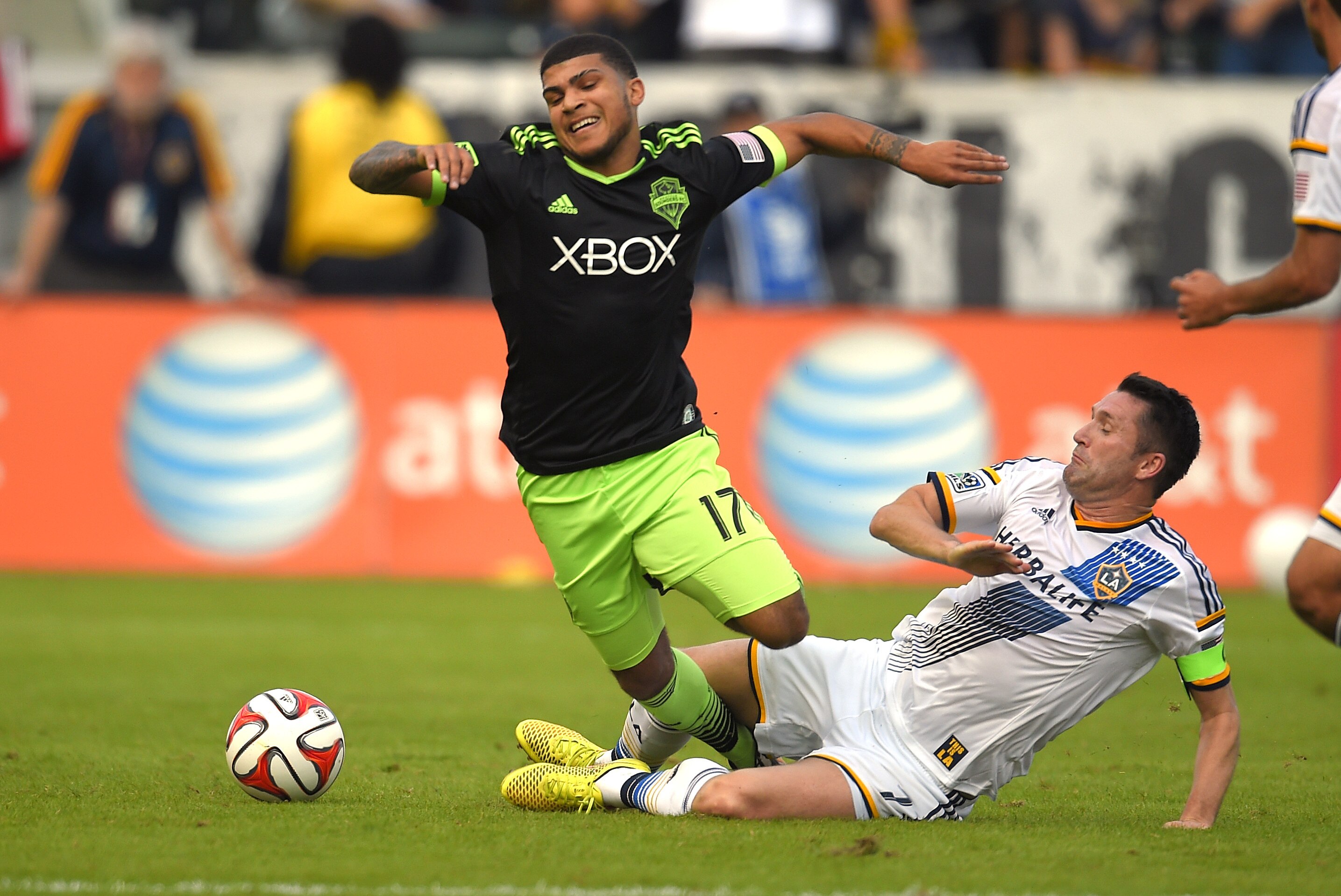 Seattle Sounders FC defender Deindre Yedlin, left, falls as Los Angeles Galaxy forward Robbie Keane goes after the ball during the first half of a Major League Soccer playoff game, Sunday, Nov. 23, 2014, in Carson, Calif. (AP Photo/Mark J. Terrill)