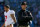 CHARLOTTE, NC - JANUARY 12:  Head coach Jim Harbaugh of the San Francisco 49ers looks on in the second quarter as Colin Kaepernick #7 walks by against the Carolina Panthers during the NFC Divisional Playoff Game at Bank of America Stadium on January 12, 2014 in Charlotte, North Carolina.  (Photo by Ronald Martinez/Getty Images)