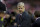 Arsenal's manager Arsene Wenger takes to the touchline before his team's English Premier League soccer match against Liverpool at Anfield Stadium, Liverpool, England, Sunday Dec. 21, 2014. (AP Photo/Jon Super)