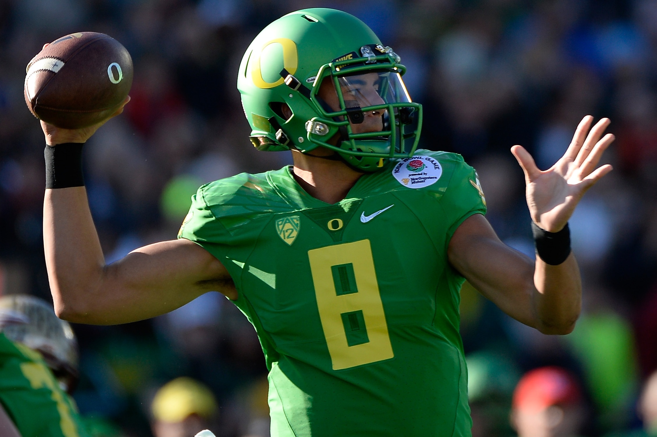 PASADENA, CA - JANUARY 01: Quarterback Marcus Mariota #8 of the Oregon Ducks looks to pass the ball against the Florida State Seminoles during the College Football Playoff Semifinal at the Rose Bowl Game presented by Northwestern Mutual at the Rose Bowl on January 1, 2015 in Pasadena, California. (Photo by Harry How/Getty Images)
