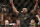 Jon Jones celebrates after defeating Daniel Cormier during their light heavyweight title mixed martial arts bout at UFC 182, Saturday, Jan. 3, 2015, in Las Vegas. (AP Photo/John Locher)