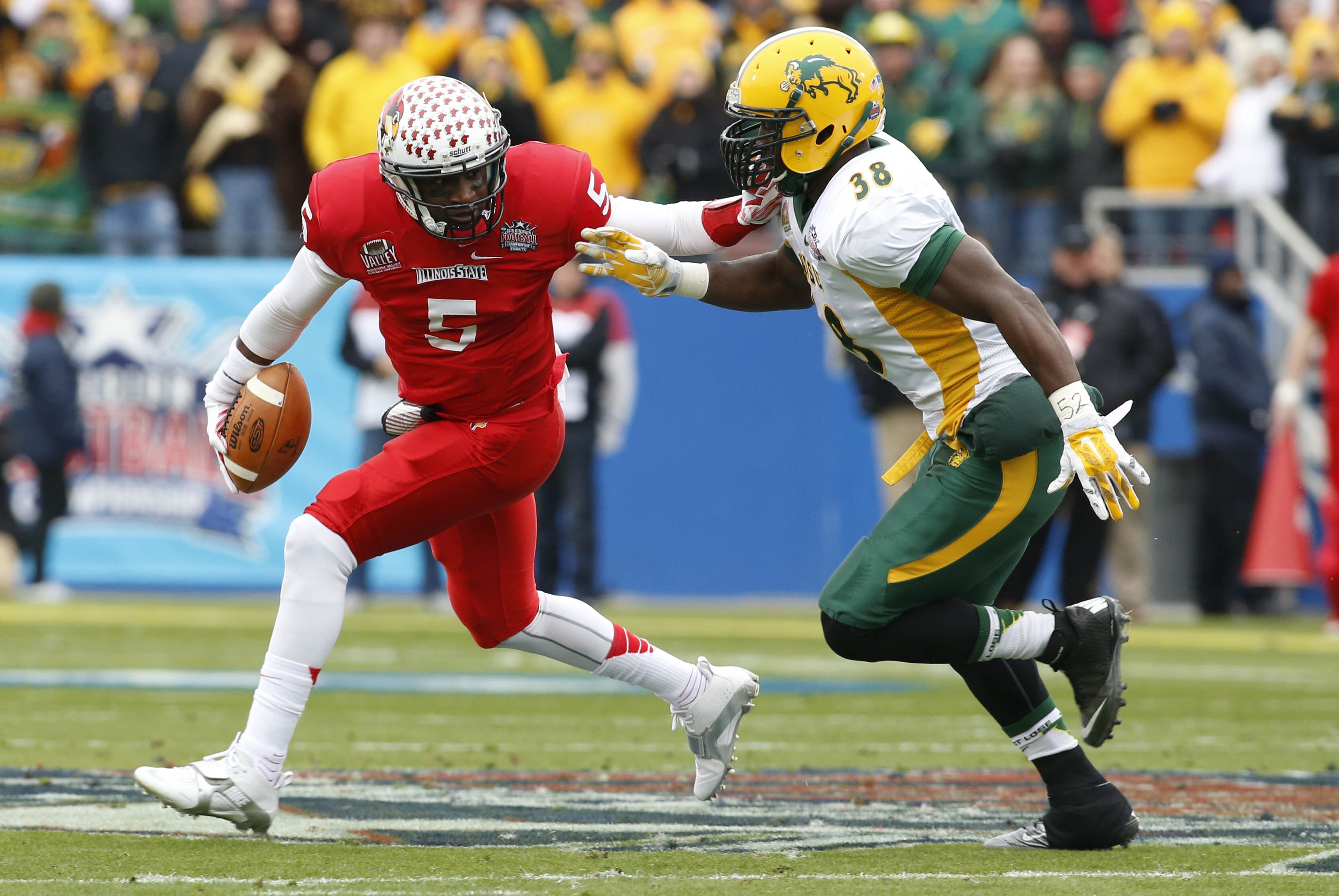 Jan 10, 2015; Frisco, TX, USA; Illinois State Redbirds quarterback Tre Roberson (5) is pursued by North Dakota State Bison linebacker Carlton Littlejohn (38) in the first quarter of the Division I championship at Pizza Hut Park. Mandatory Credit: Tim Heitman-USA TODAY Sports