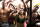 In this image released by GoDaddy.com on Wednesday, Jan. 22, 2014, NASCAR driver Danica Patrick, center, wearing a muscle suit, appears with bodybuilders in an upcoming Super Bowl commercial shot on location in Long Beach, Calif. The commercial is expected to air during the second half of NFL football's Super Bowl XLVIII on Sunday,  Feb. 2. (AP Photo/GoDaddy.com)