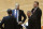 New York Knicks coach Derek Fisher, second from left, and associate coach Kurt Rambis, right, gather with assistant coaches during a timeout in the second half of the Knicks' NBA basketball game against the Sacramento Kings on Tuesday, March 3, 2015, in New York. The Kings won 124-86. (AP Photo/Frank Franklin II)