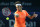 Roger Federer of Switzerland returns the ball to Novak Djokovic of Serbia during the final match of the Dubai Duty Free Tennis Championships in Dubai, United Arab Emirates, Saturday, Feb. 28, 2015. (AP Photo/Kamran Jebreili)