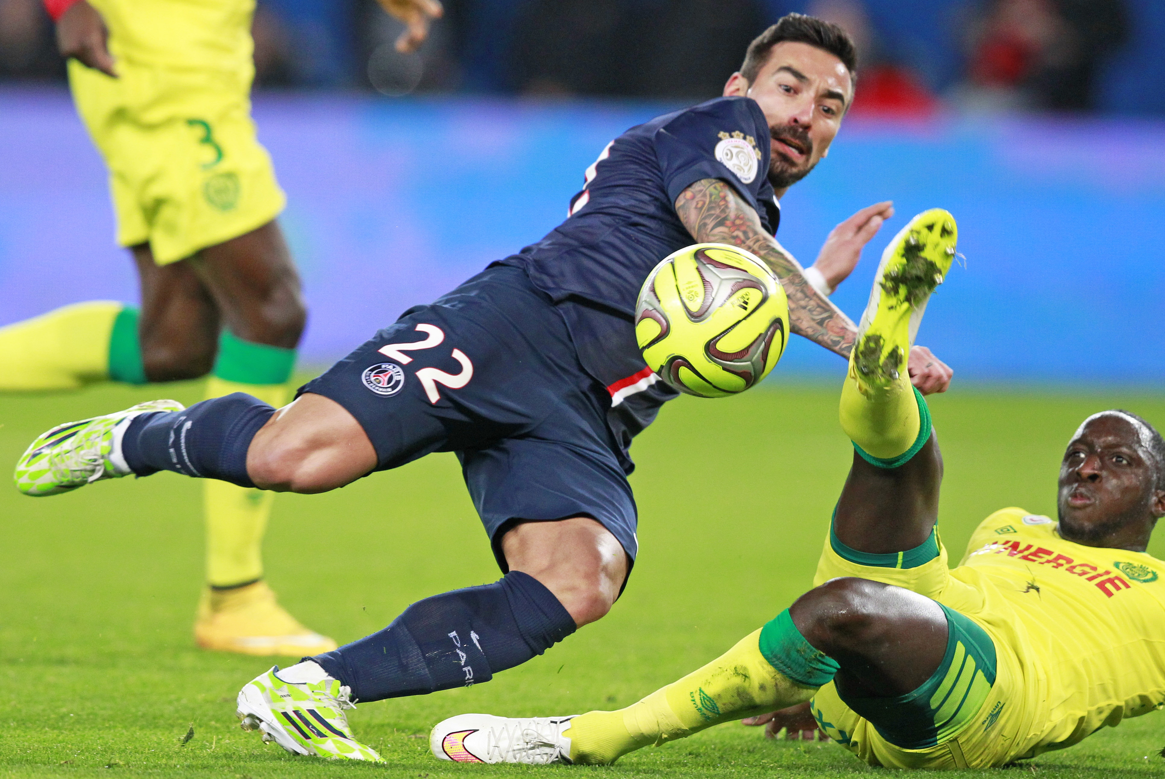PSG player Ezequiel Lavezzi, top, vies for the ball vith Nantes player Issa Cissokho during the French League One soccer match between Paris Saint Germain and Nantes, at the Parc des Princes stadium in Paris, Saturday Dec. 6, 2014. (AP Photo/Remy de la Mauviniere)