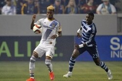 April 18, 2015; Carson, CA, USA; Los Angeles Galaxy forward Bradford Jamieson (38) controls the ball against Sporting KC defender Jalil Anibaba (23) during the first half at StubHub Center. Mandatory Credit: Gary A. Vasquez-USA TODAY Sports