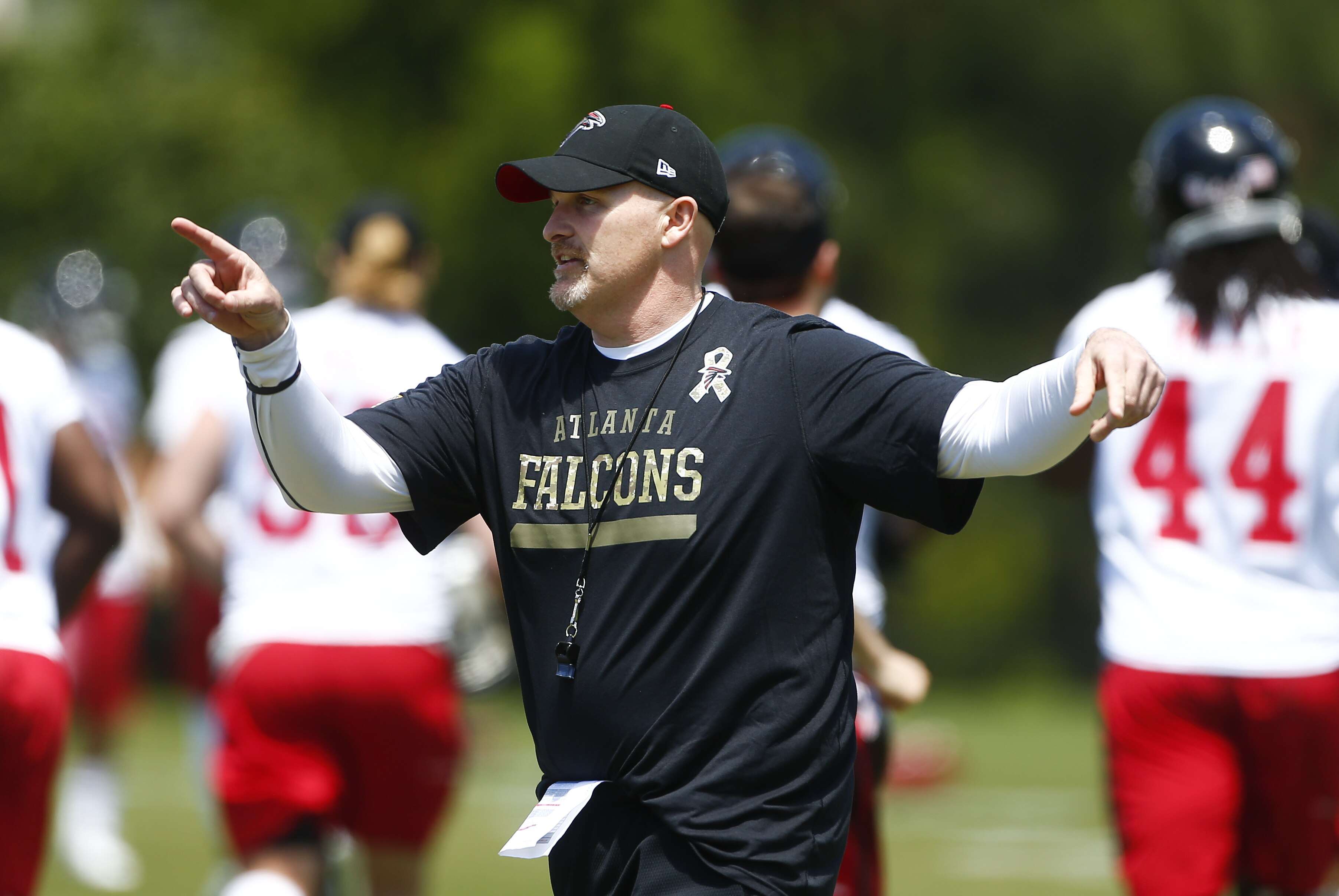Atlanta Falcons head coach Dan Quinn direct his team during an NFL football minicamp practice Tuesday, April 28, 2015, in Flowery Branch, Ga. The workout was Quinn's first as head coach. (AP Photo/John Bazemore)