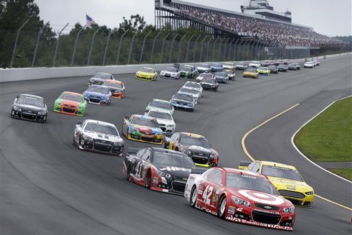 Kyle Larson (42) leads a pack of cars at the start of the NASCAR Sprint Cup Series auto race at Pocono Raceway, Sunday, Aug. 3, 2014, Long Pond, Pa. (AP Photo/Mel Evans)