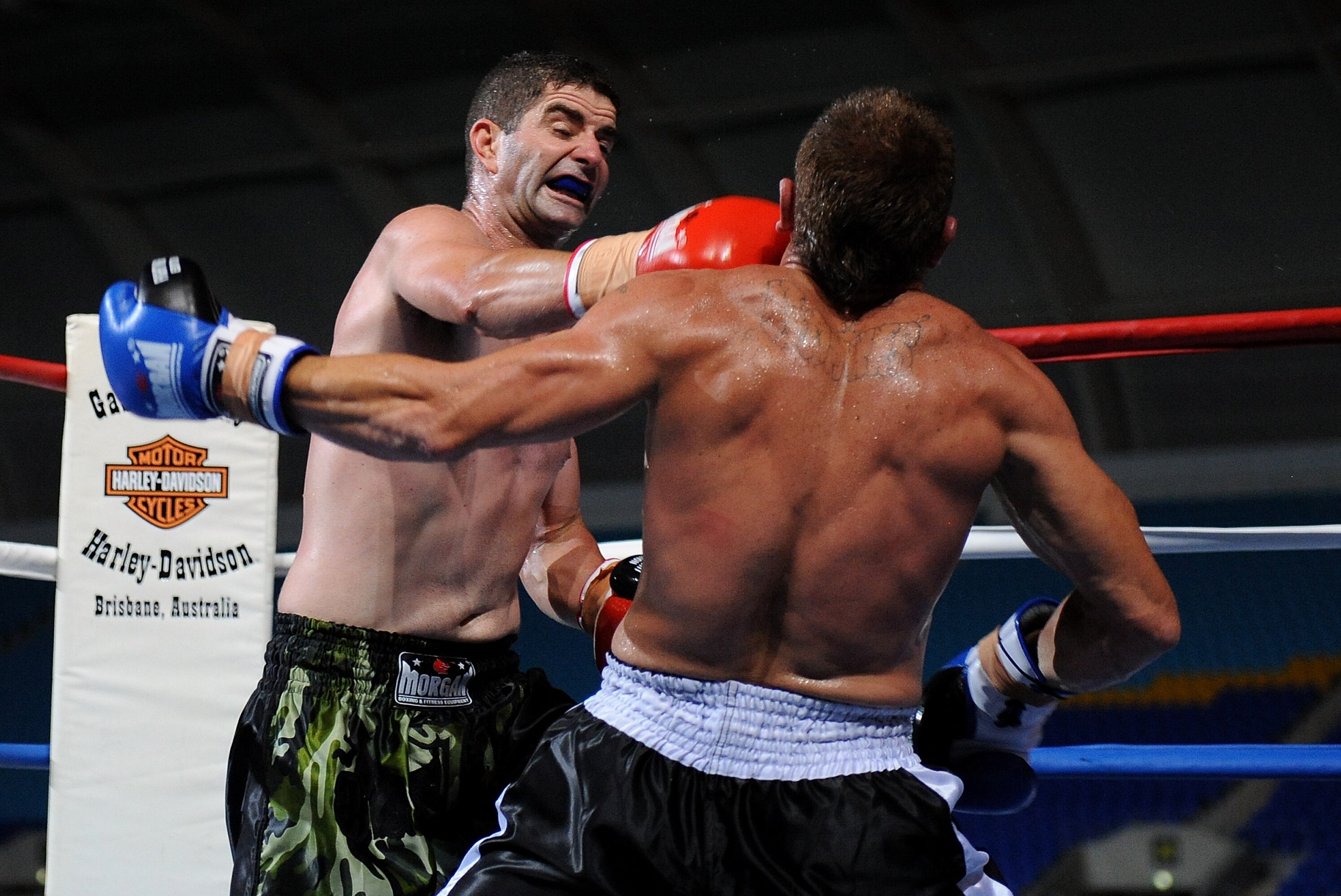 GOLD COAST, AUSTRALIA - MARCH 24: Darren Finn (L) throws a punch during the middleweight boxing Title bout between Darren Finn of Australia and Evan Stewart of Australia at Skilled Park on March 24, 2012 on the Gold Coast, Australia. (Photo by Matt Roberts/Getty Images)