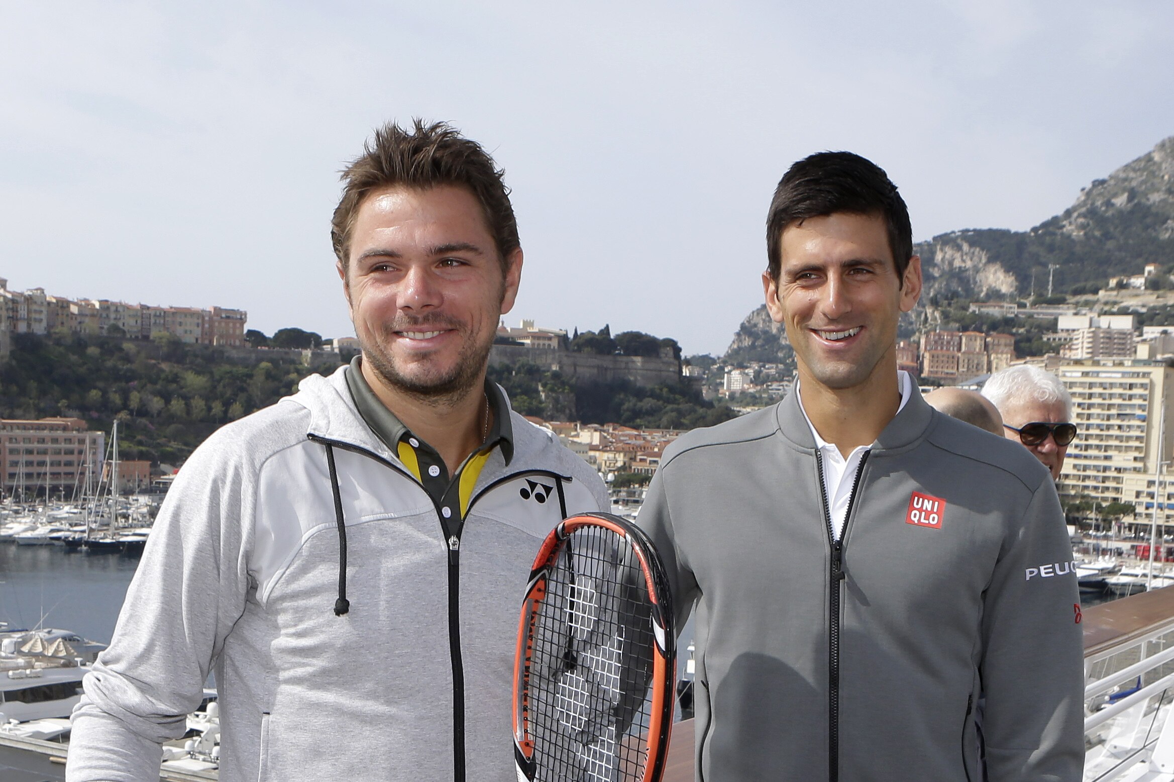 Stanislas Wawrinka of Switzerland, left, and Novak Djokovic of Serbia pose for photographers during an exhibition match, in Monaco, Saturday, April 11, 2015, during the Monte Carlo Tennis Masters tournament. (AP Photo/Lionel Cironneau)